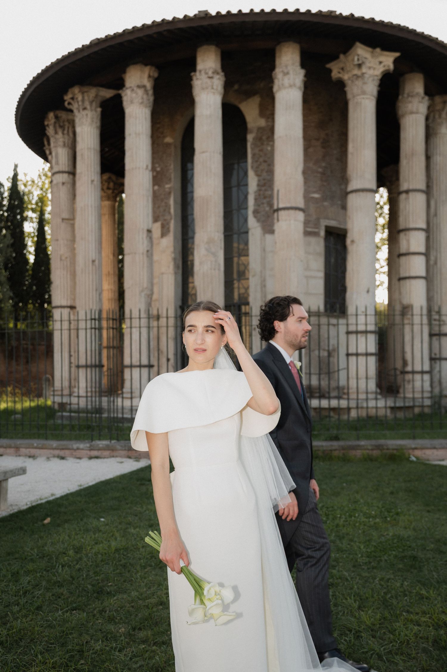 Wedding photography session in front of historic temple with dramatic columns and architecture.