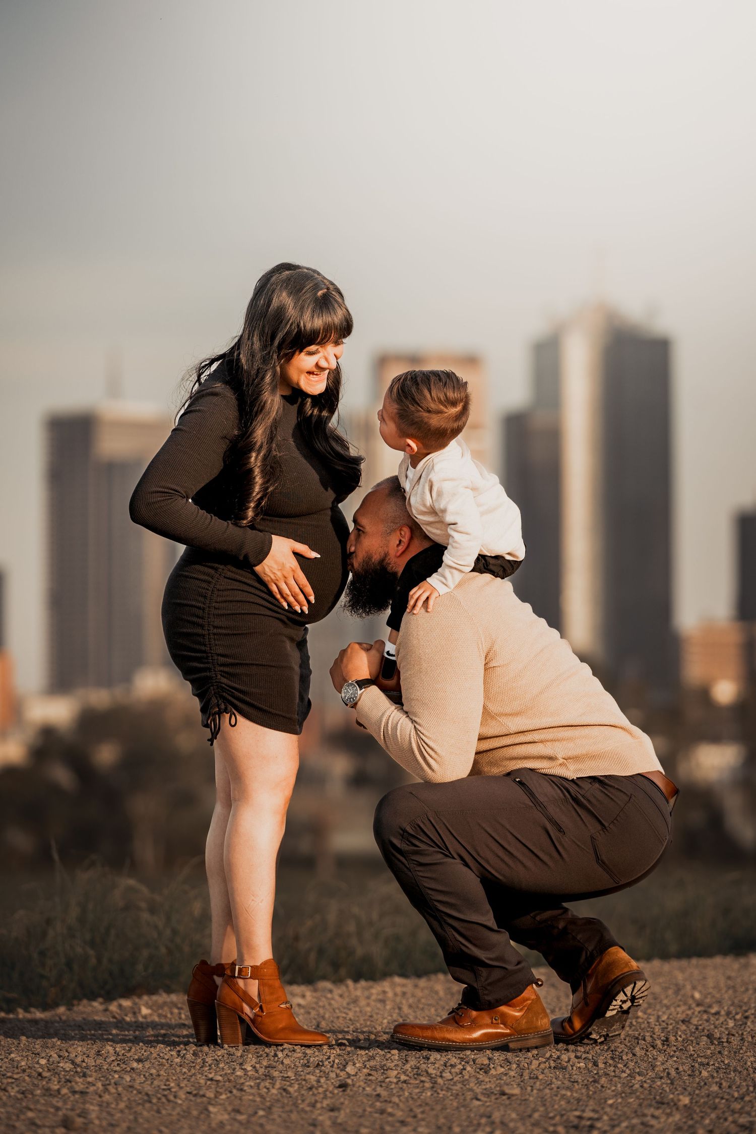 Two people share an intimate moment with a cityscape in the background.