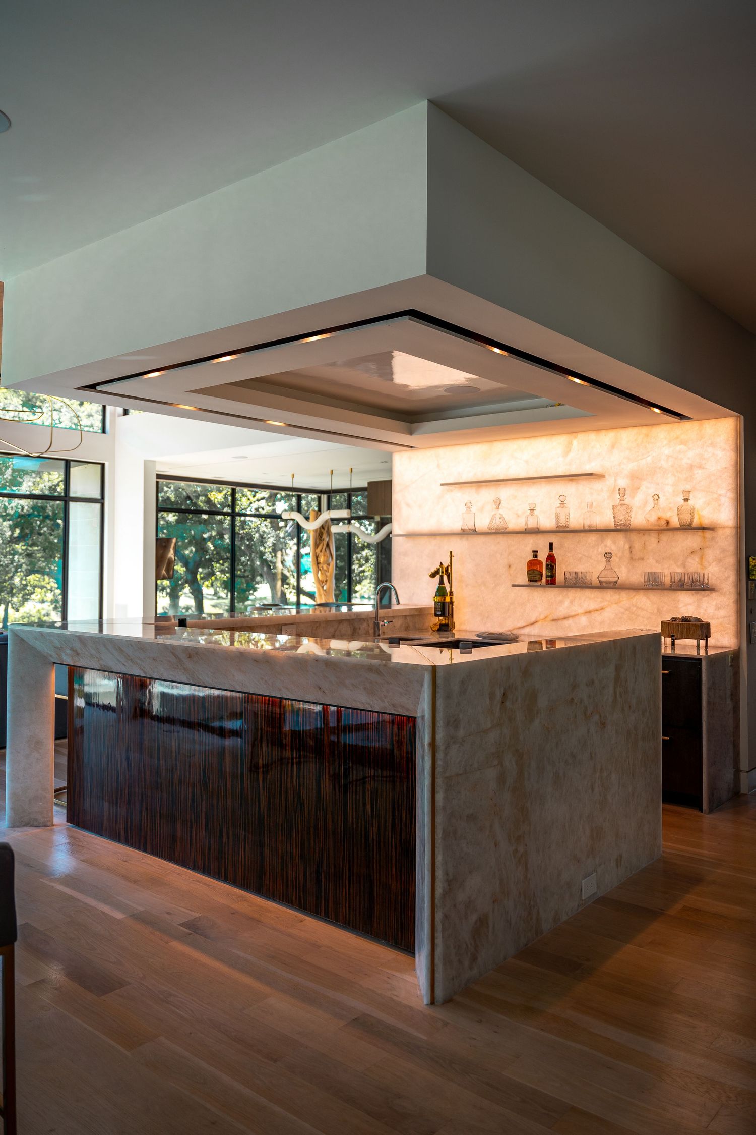 Contemporary kitchen design with illuminated floating shelves and minimalist concrete finishes.