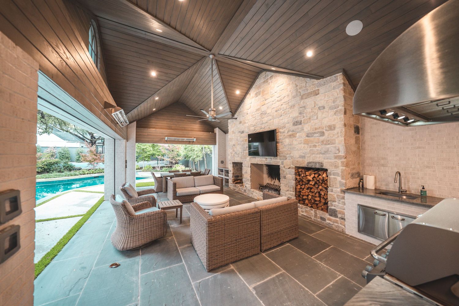 Modern luxury home interior featuring wood ceiling details, recessed lighting, and an open concept living space.