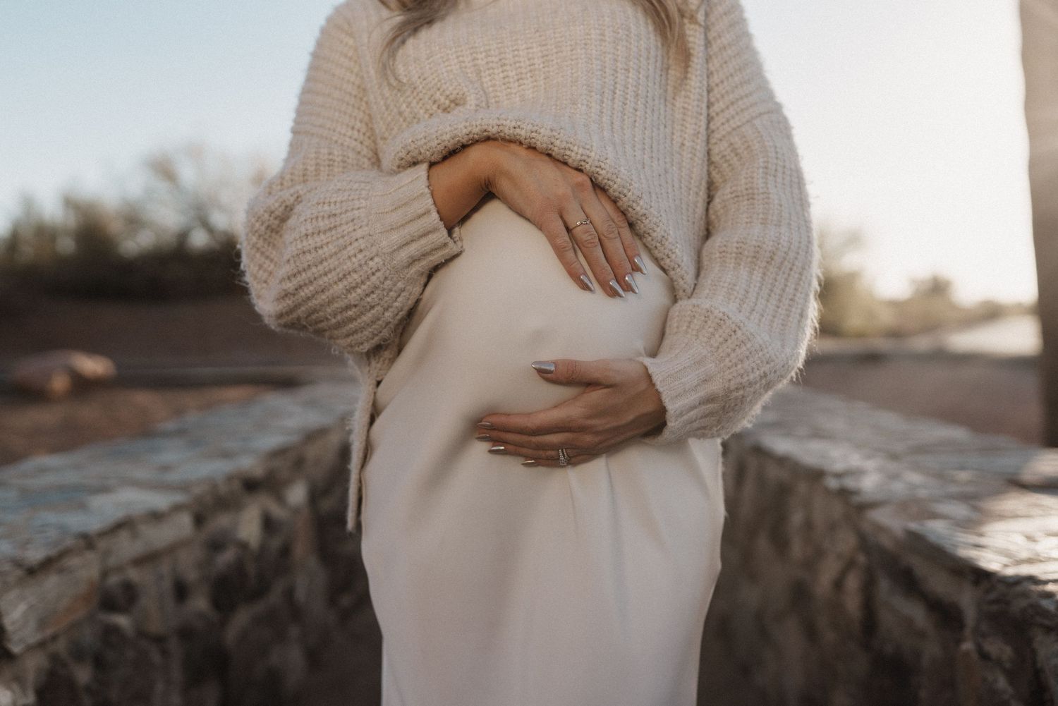 Pregnancy photography session at sunset in Fate TX, flowing dress and the perfect tones.