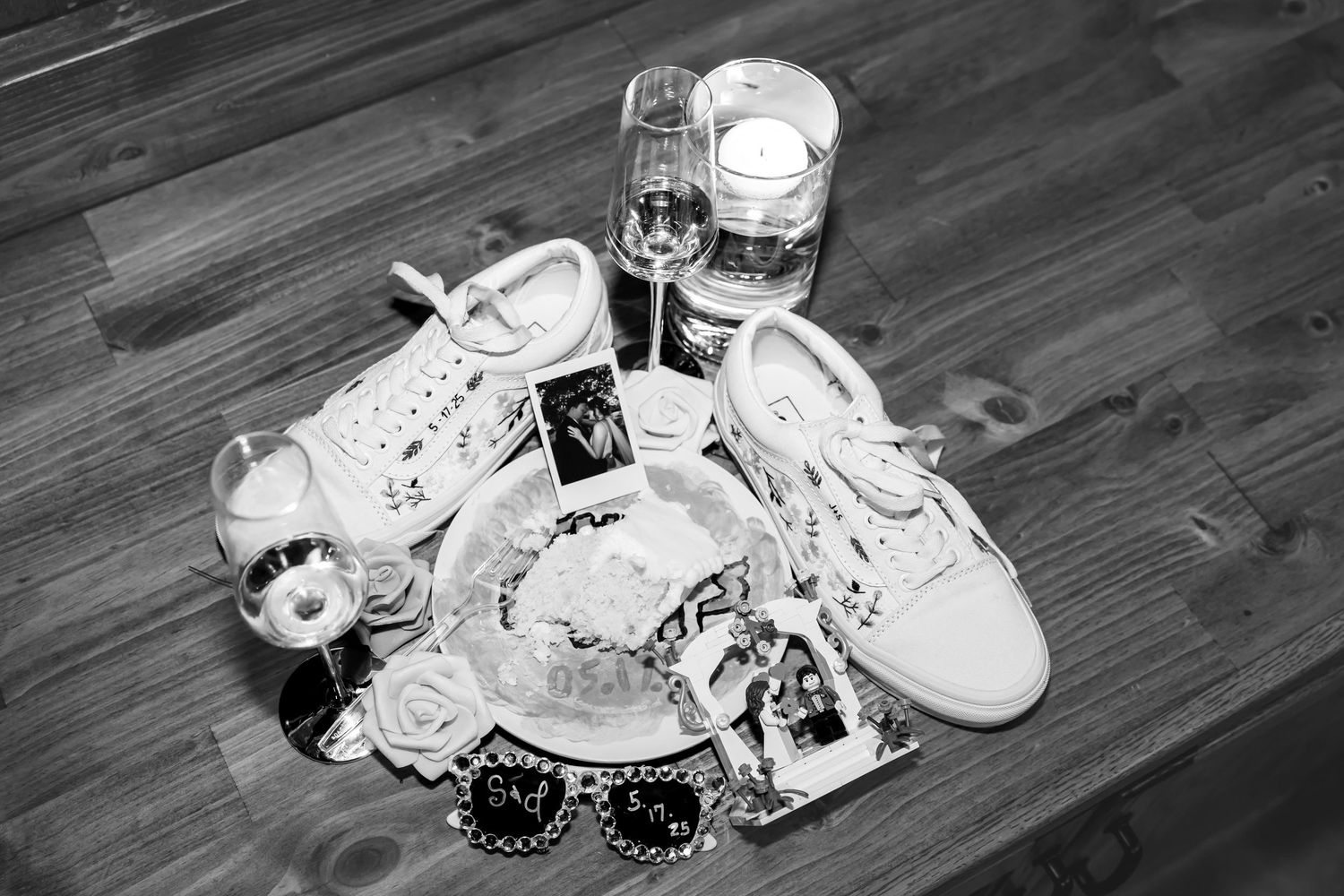 wedding detail photo showing bride's shoes, champagne glasses, polaroid photo, and wedding cake for wedding photos in Jefferson City MO