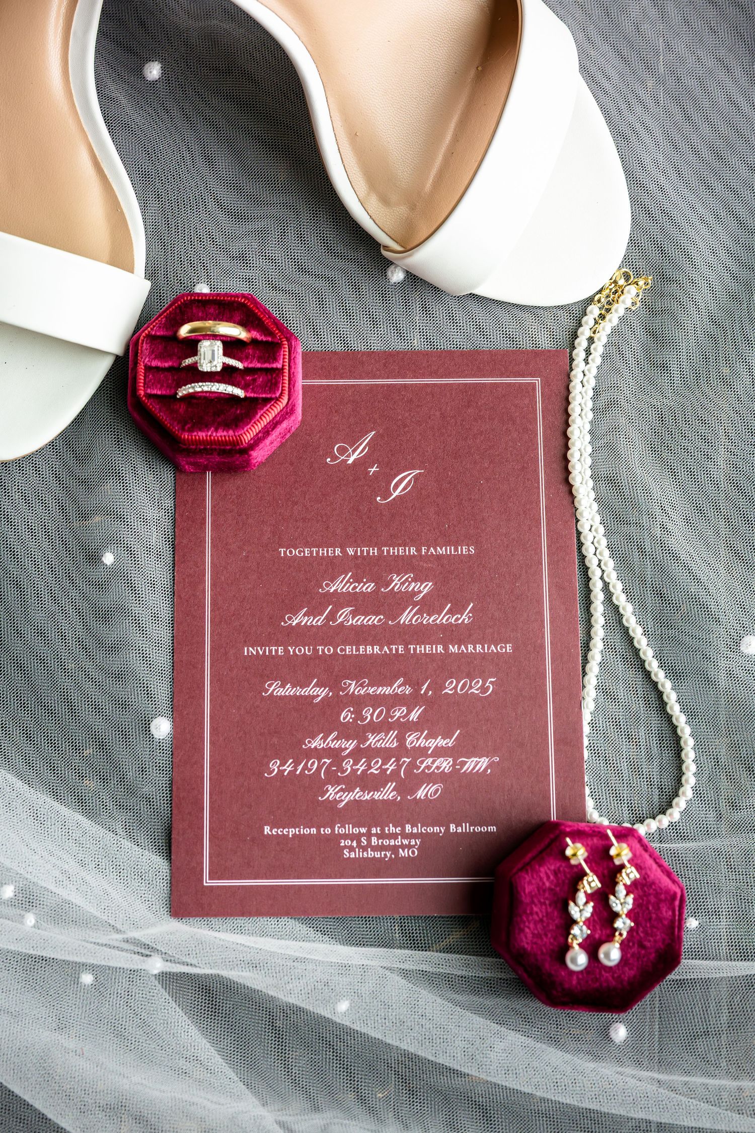 bride's wedding details including shoes, rings, necklace, and earrings on top of wedding invitation for wedding detail photos on wedding day