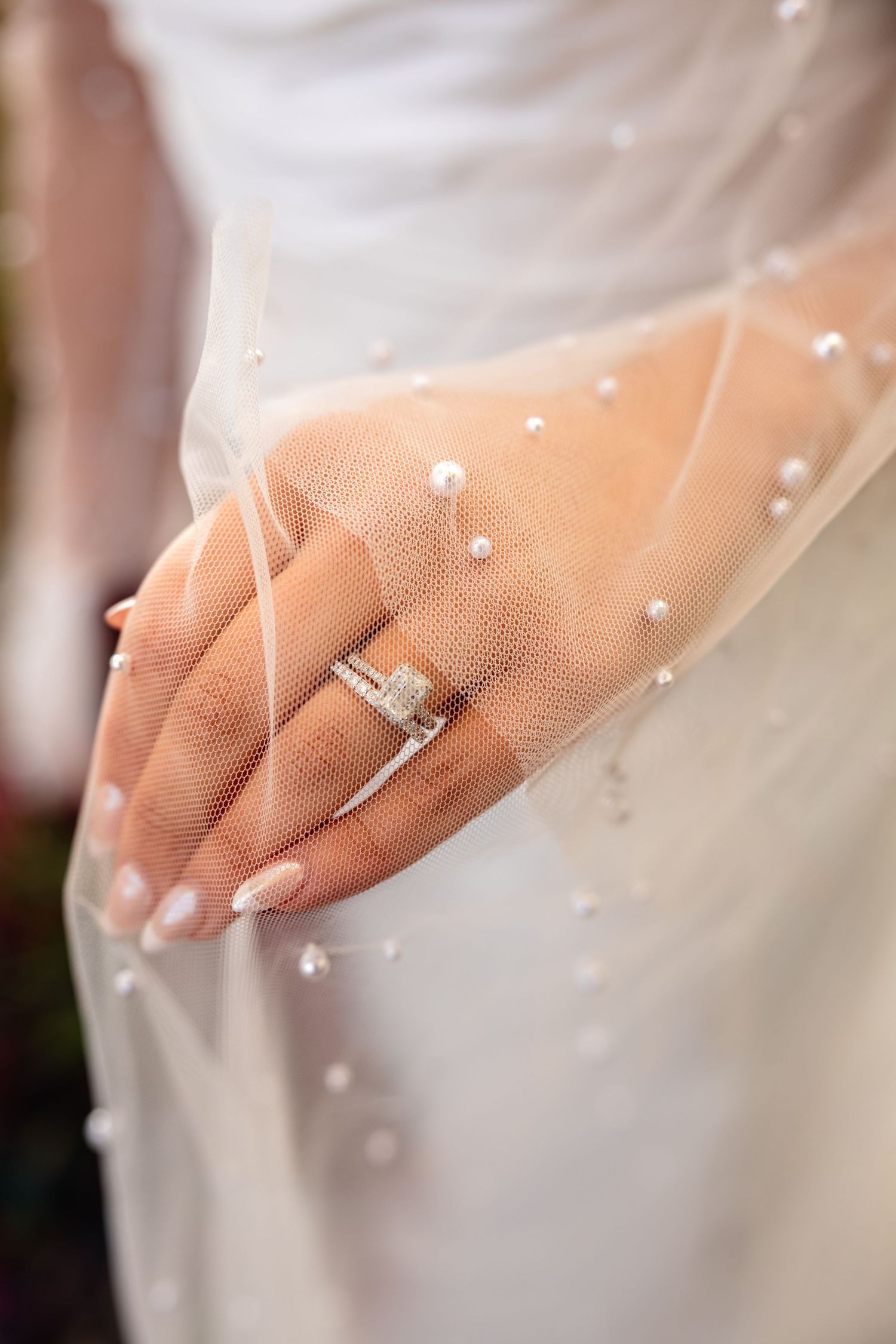 bride holding veil with wedding ring hand on wedding day near Columbia MO for wedding details photos