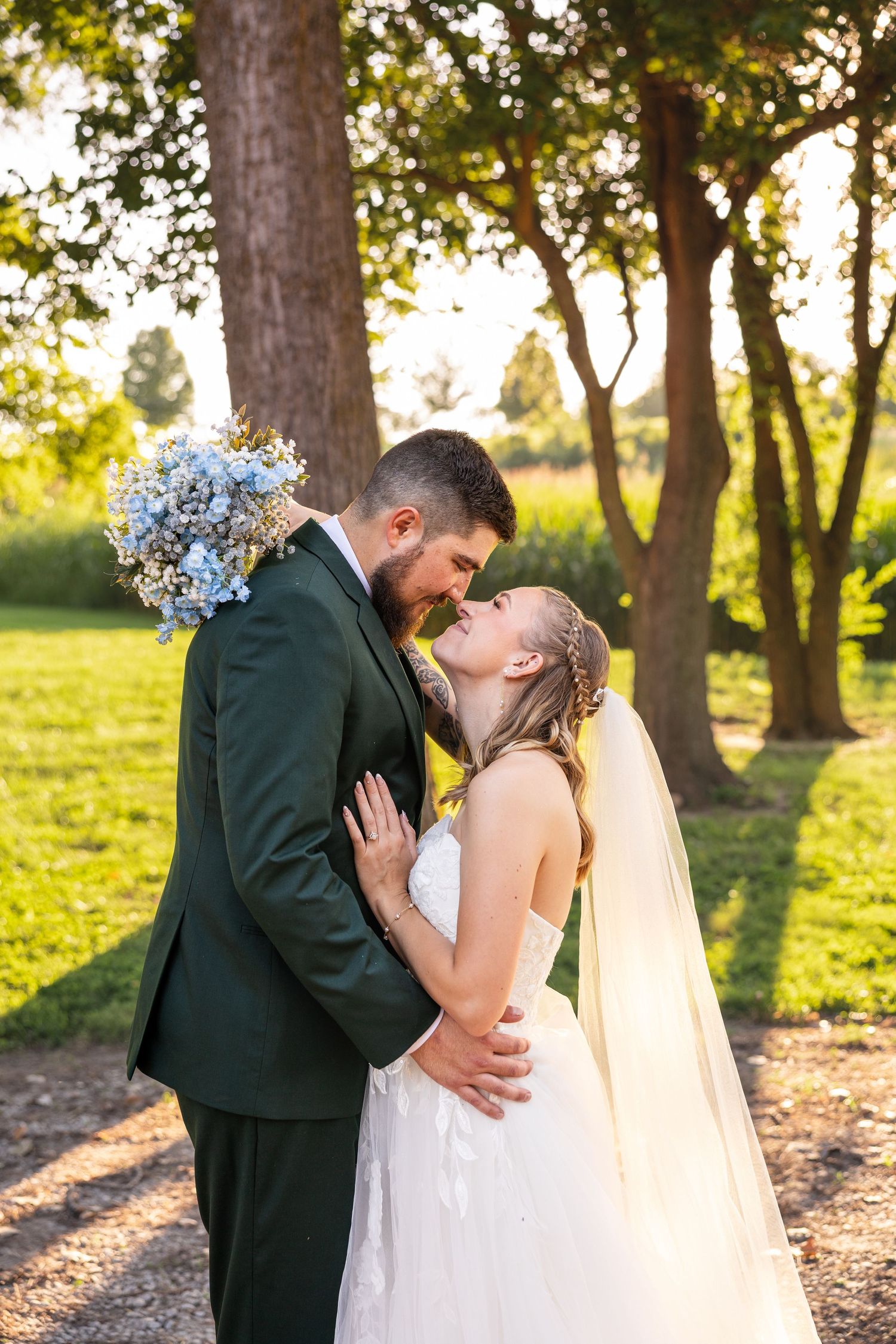 bride and groom facing each other and holding each other in embrace for photo showing bride's bouquet on wedding day in KC MO