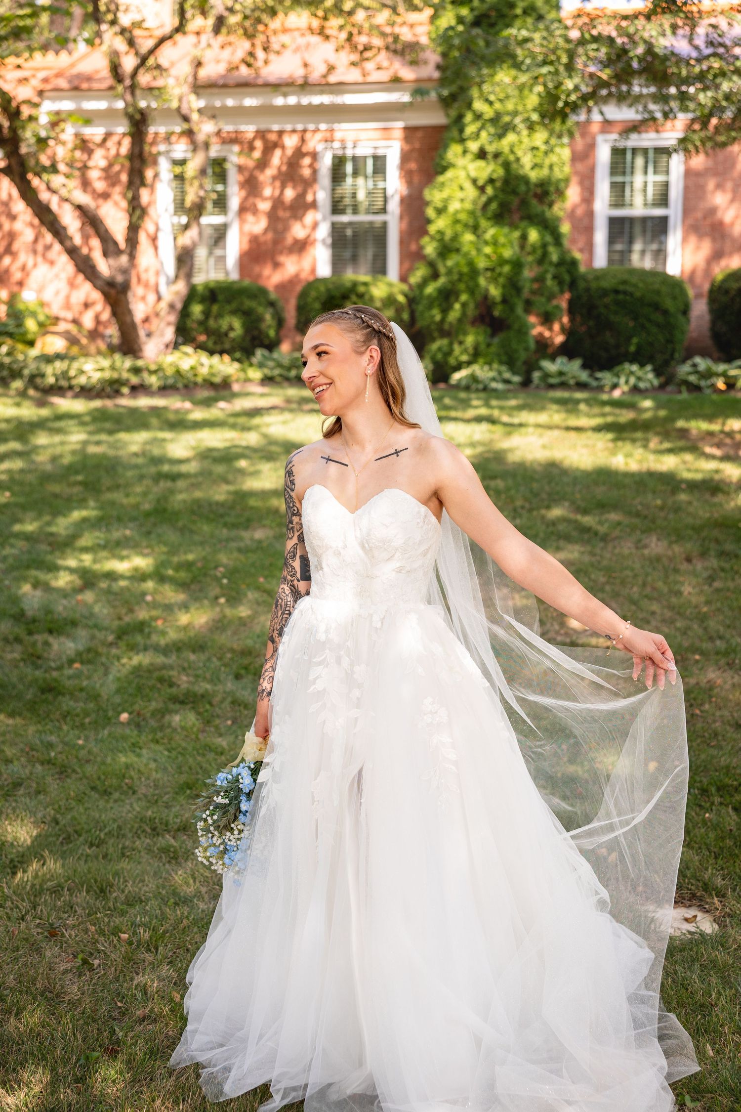 bride holding veil and bouquet in wedding dress at KC wedding venue for bridal wedding photos in Kansas City Missouri