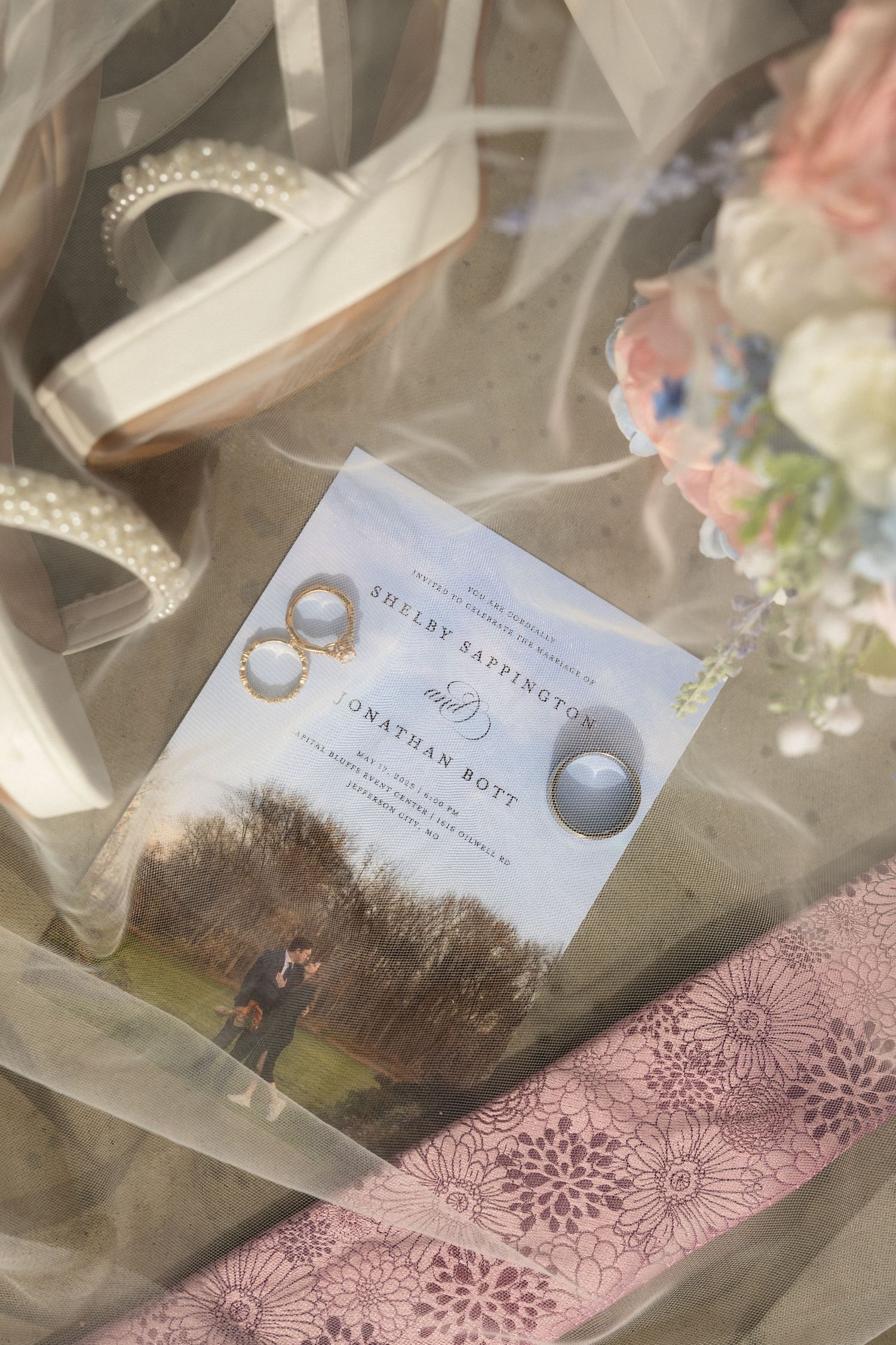 wedding detail photos showing bride and groom rings, bride's shoes, bouquet, wedding invitation, and groom's tie on wedding day in Missouri