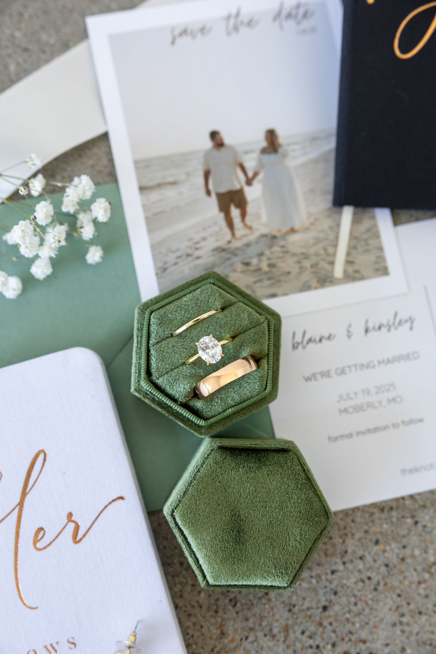 bride and groom's rings and invitation and other wedding details for wedding photos on wedding day in Moberly MO