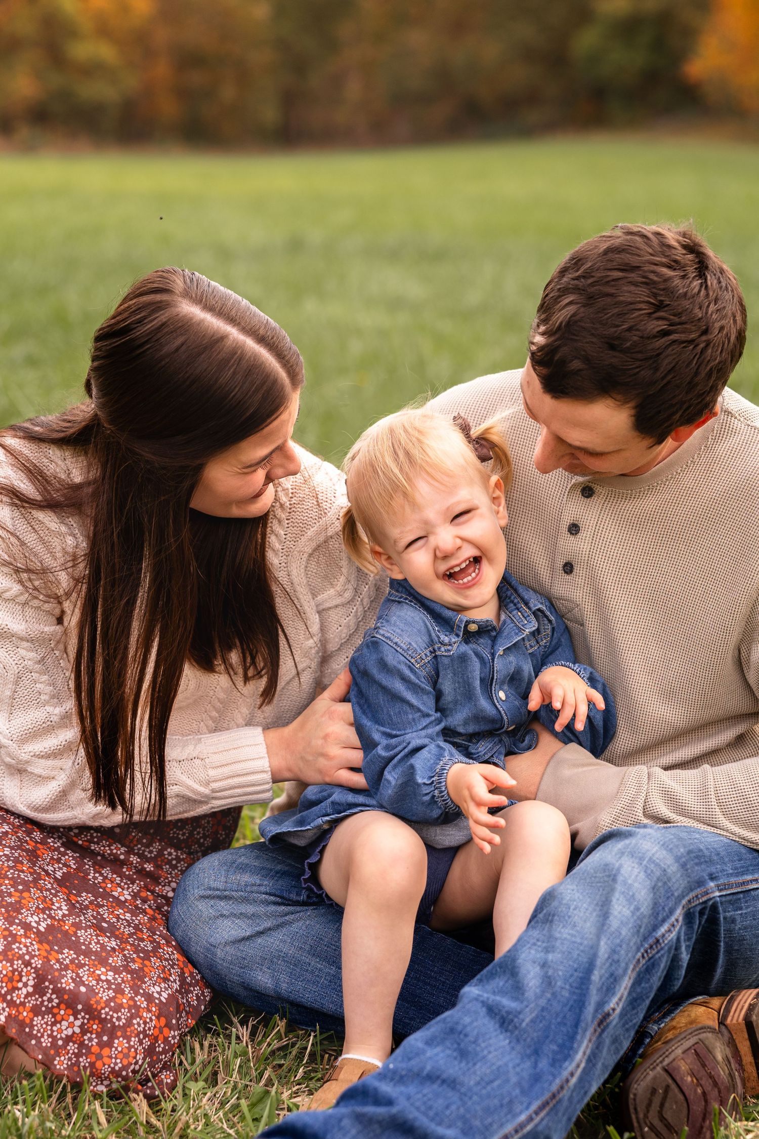family of three with toddler in mom and dads lap for family photos near Macon MO