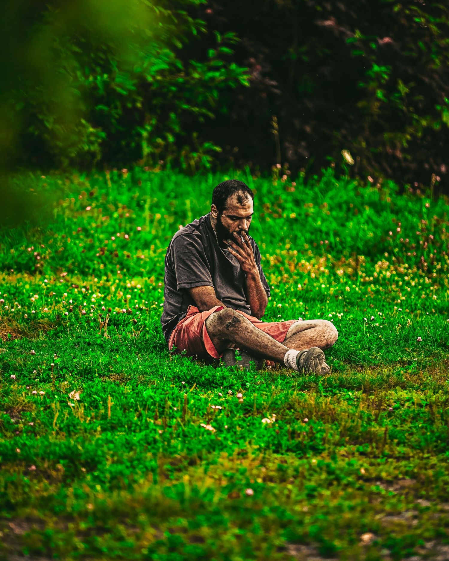 Person lying on vibrant green grass in a nature setting, creating a peaceful outdoor scene.