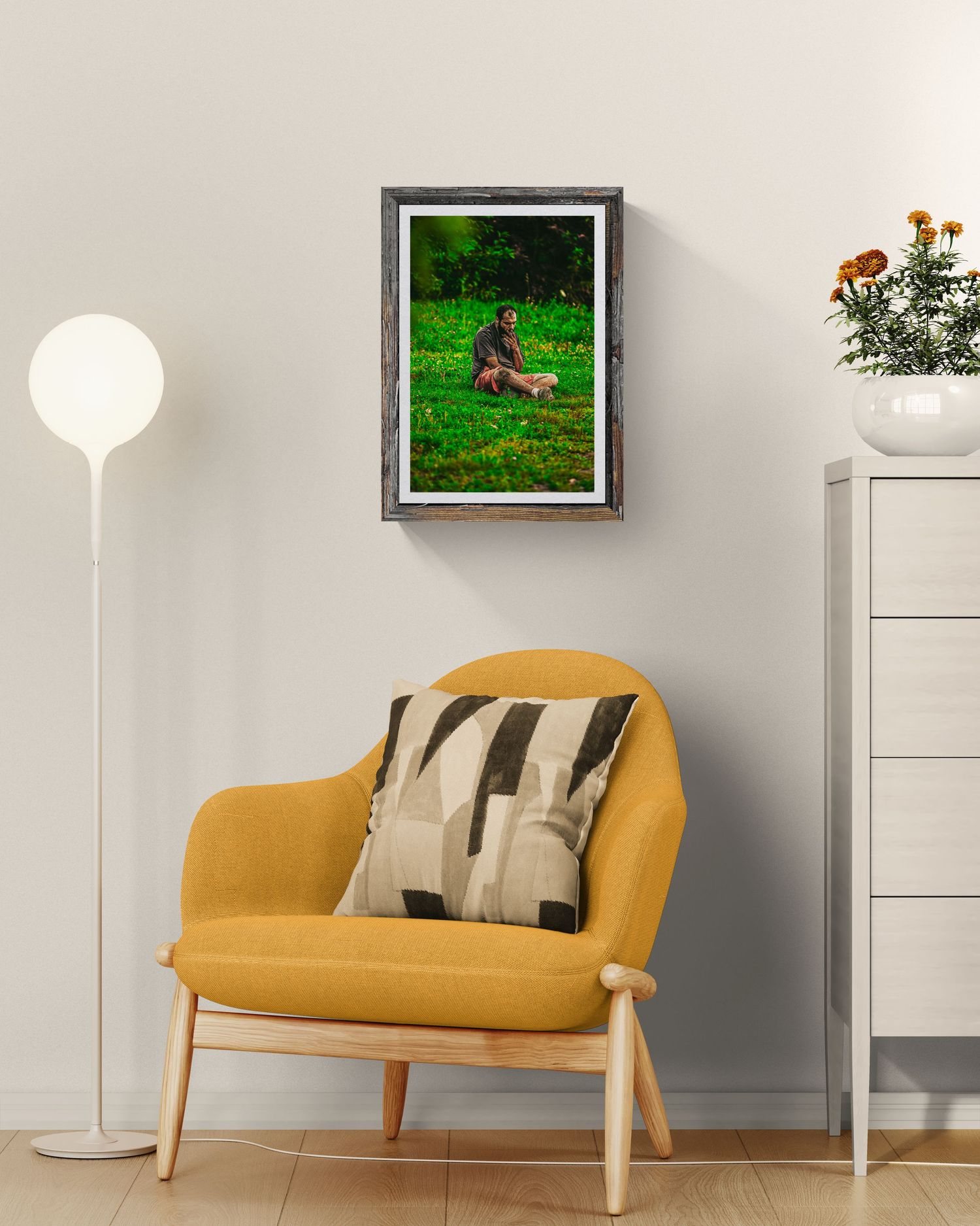Framed photo of a person with a dog on green grass, displayed above a mustard yellow chair in a modern living room.