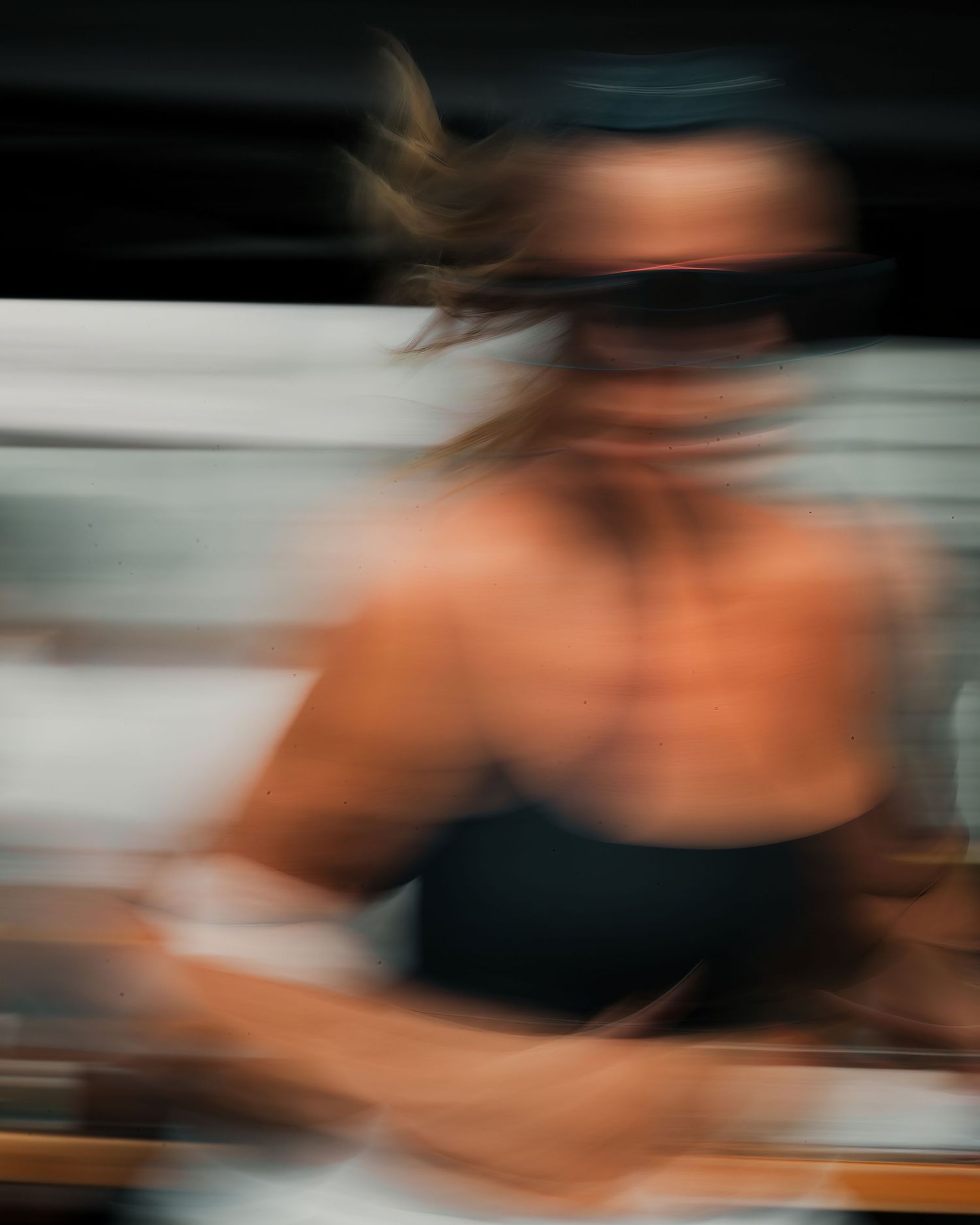 Blurred motion capture in dark tones creates abstract artistic composition.