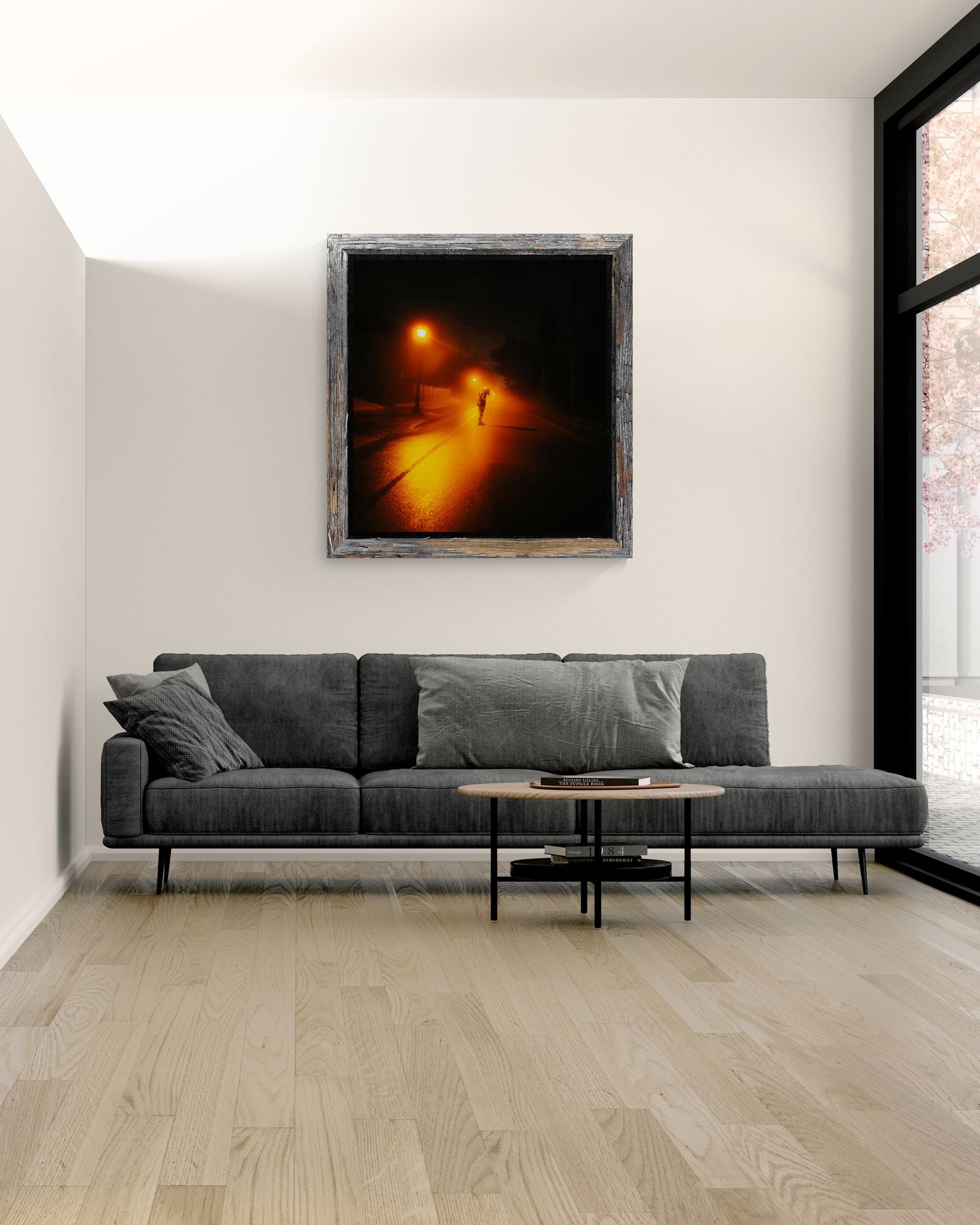 Moody night scene painting in rustic frame above gray sofa, glowing orange street lamp illuminating foggy path.