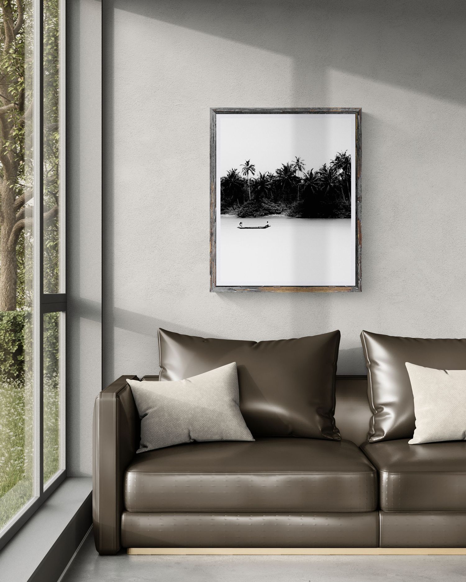 Black and white tropical river photo in dark frame above brown leather sofa in modern minimalist living room.