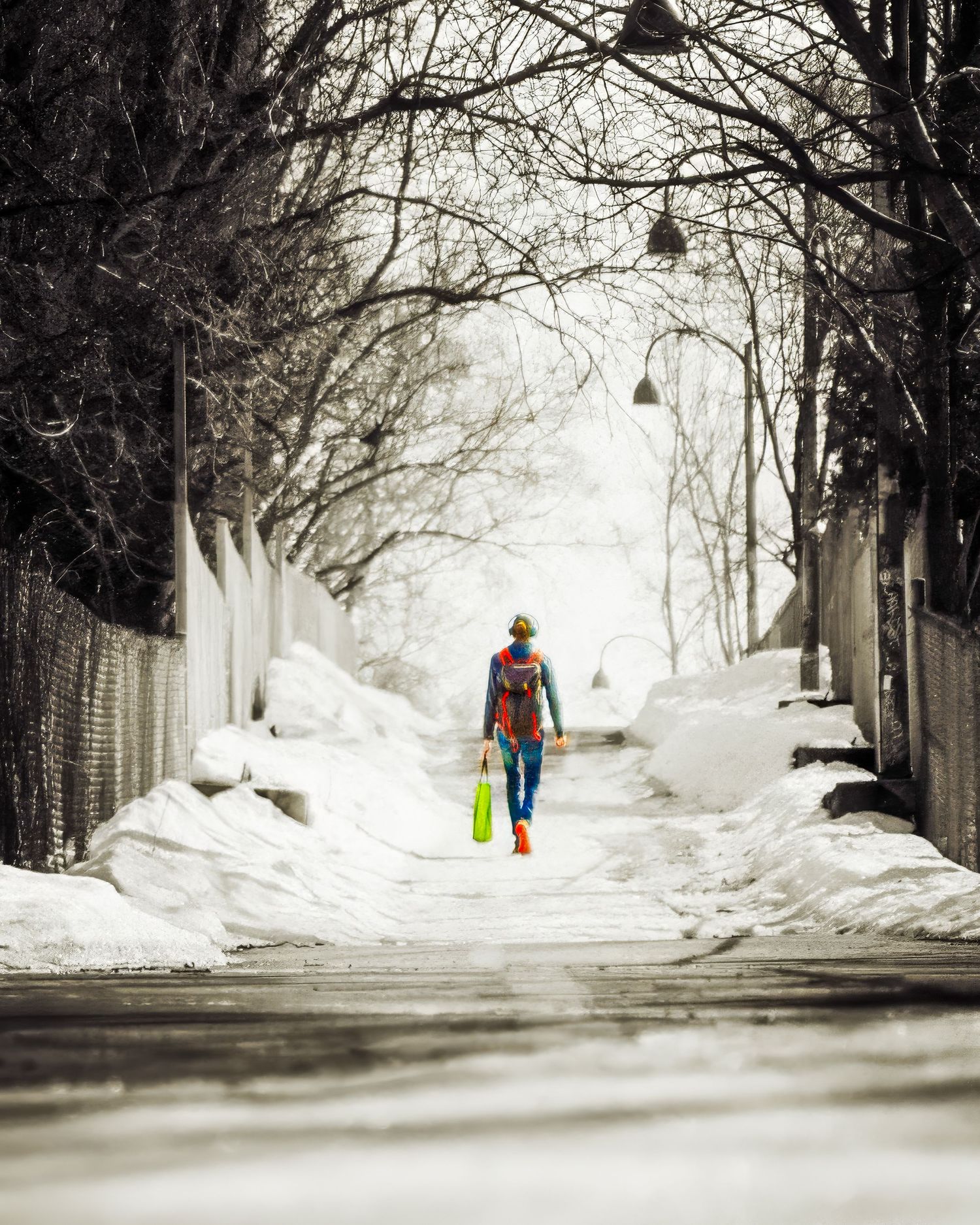 Snowy winter street scene with lamp posts and distant figures walking in the snow.