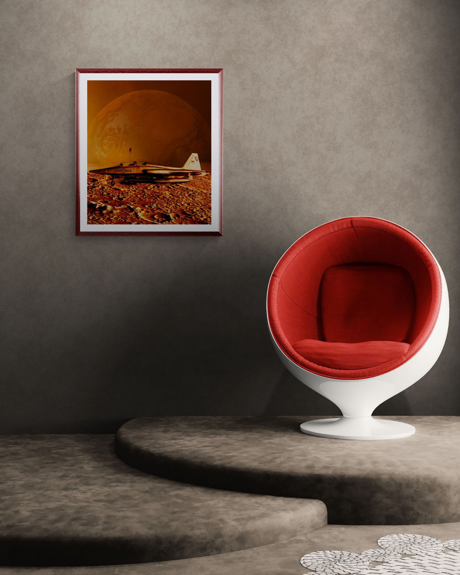 Retro red ball chair beside framed vintage airplane artwork in a modern minimalist gray interior room.