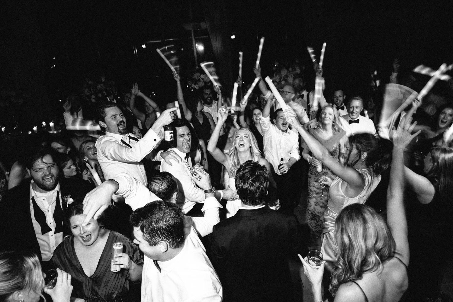 black and white image of a full wedding dance floor, with guests dancing and partying. Photographed from above