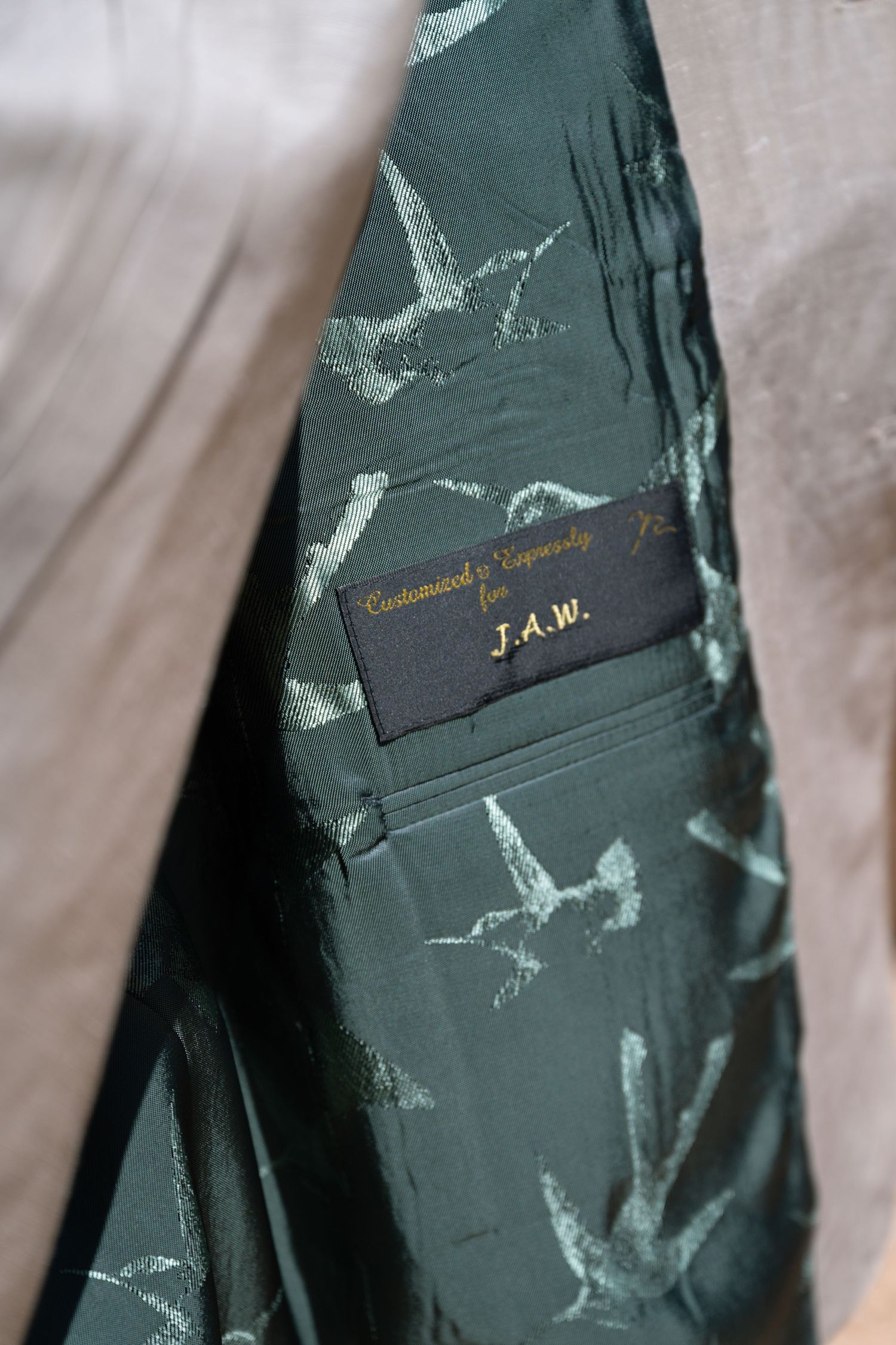 Custom suit jacket interior lining with bird pattern and personalized J.A.W. label.
