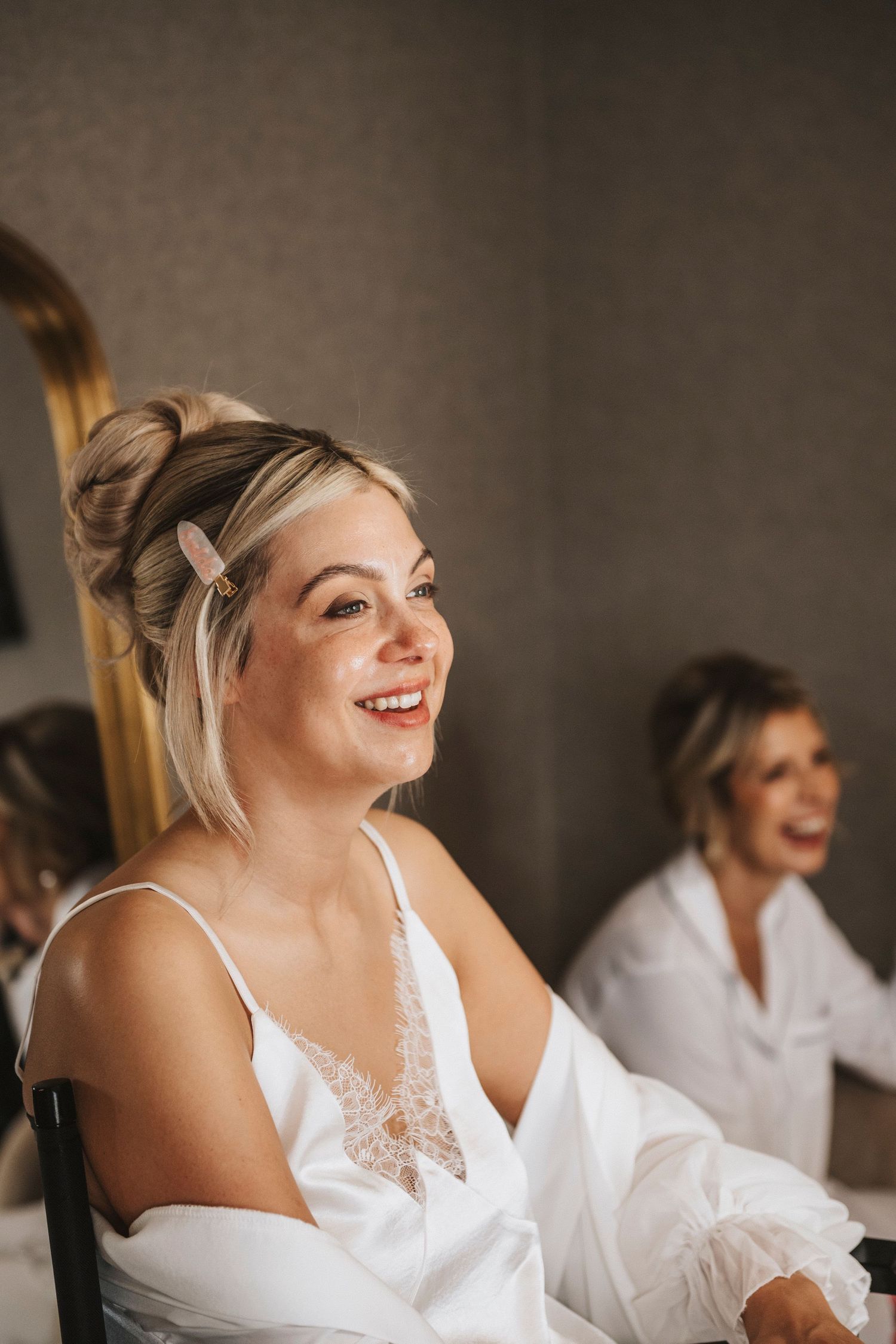 A sequence of photos showing joyful moments during wedding day preparations in white attire.