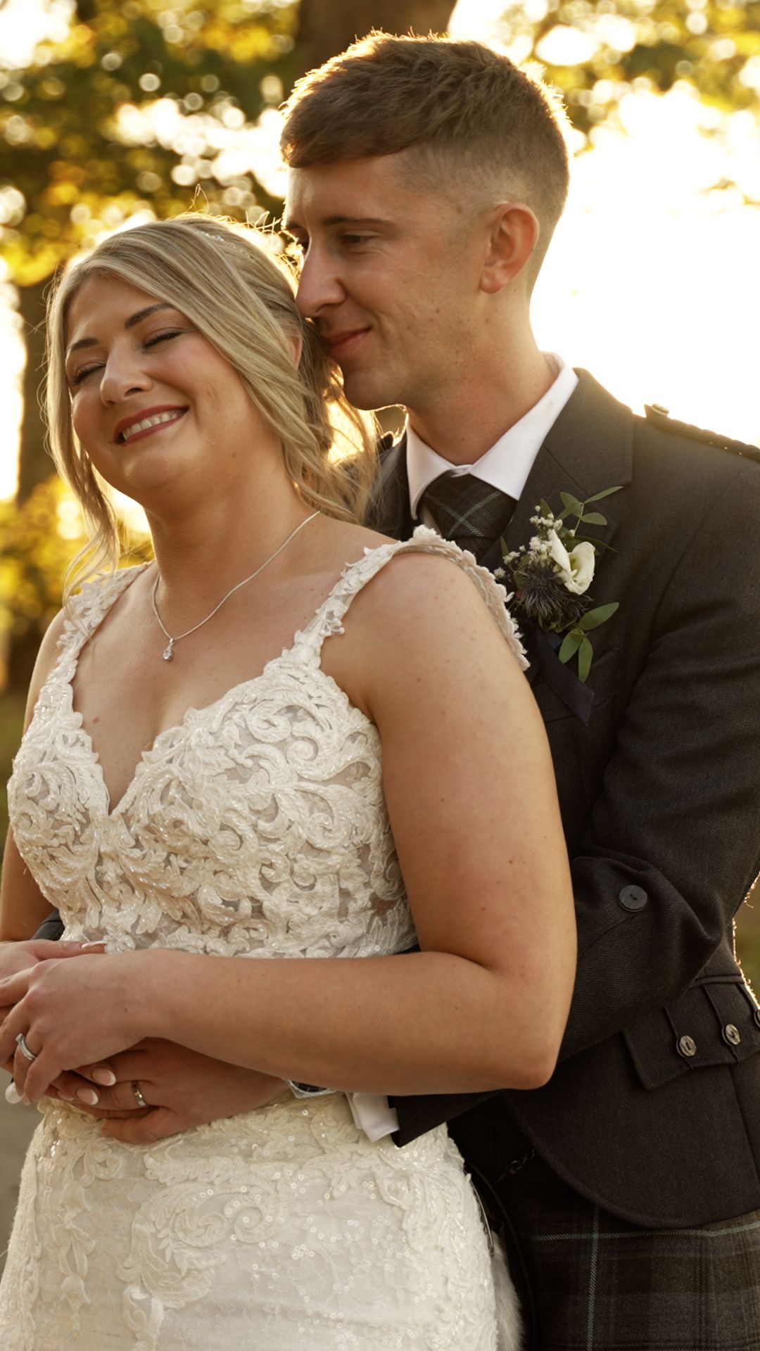 A romantic wedding couple shares intimate moments during golden hour photography session in the garden.