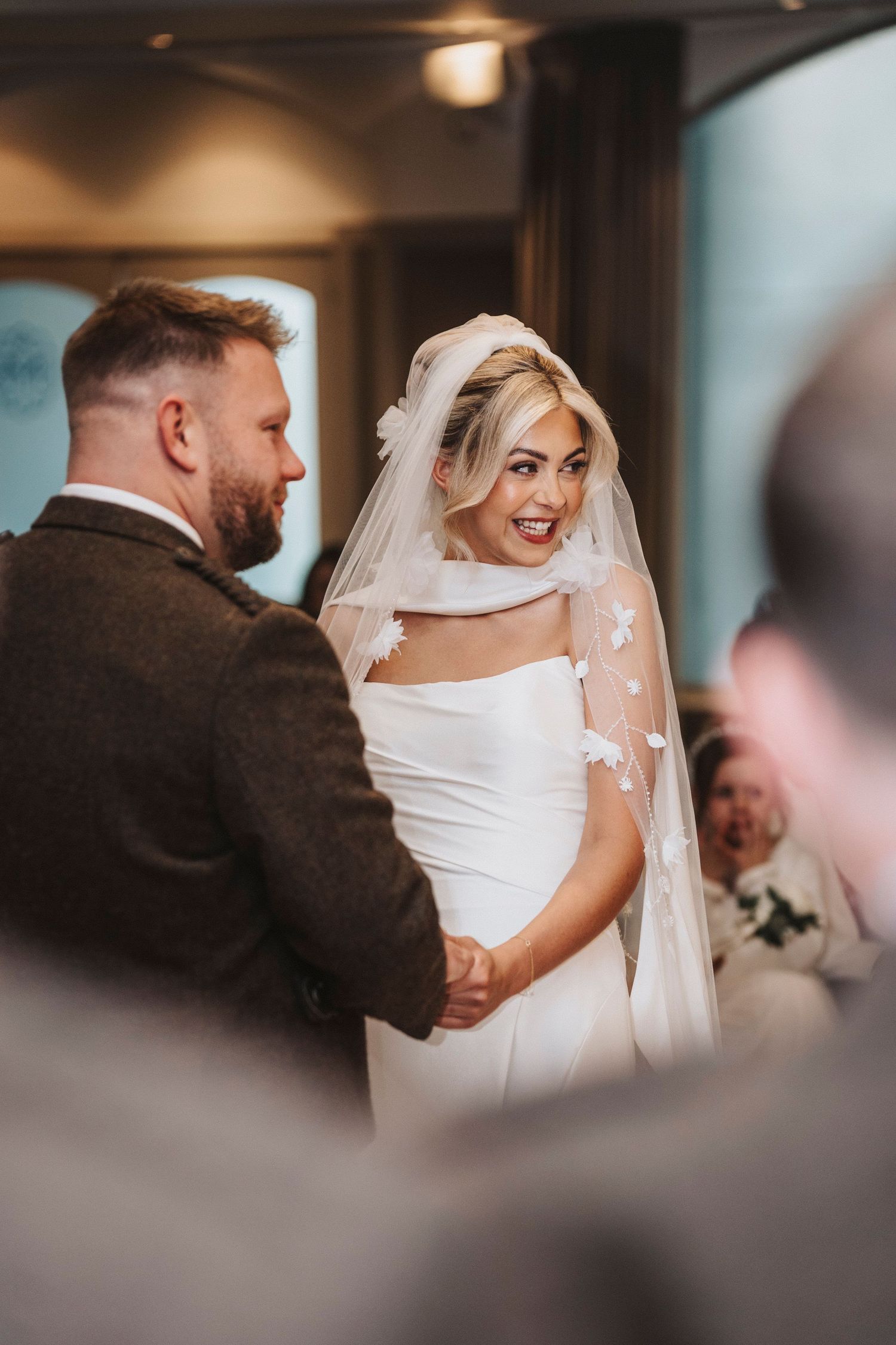 A bride and groom share an intimate first look moment during their wedding celebration.