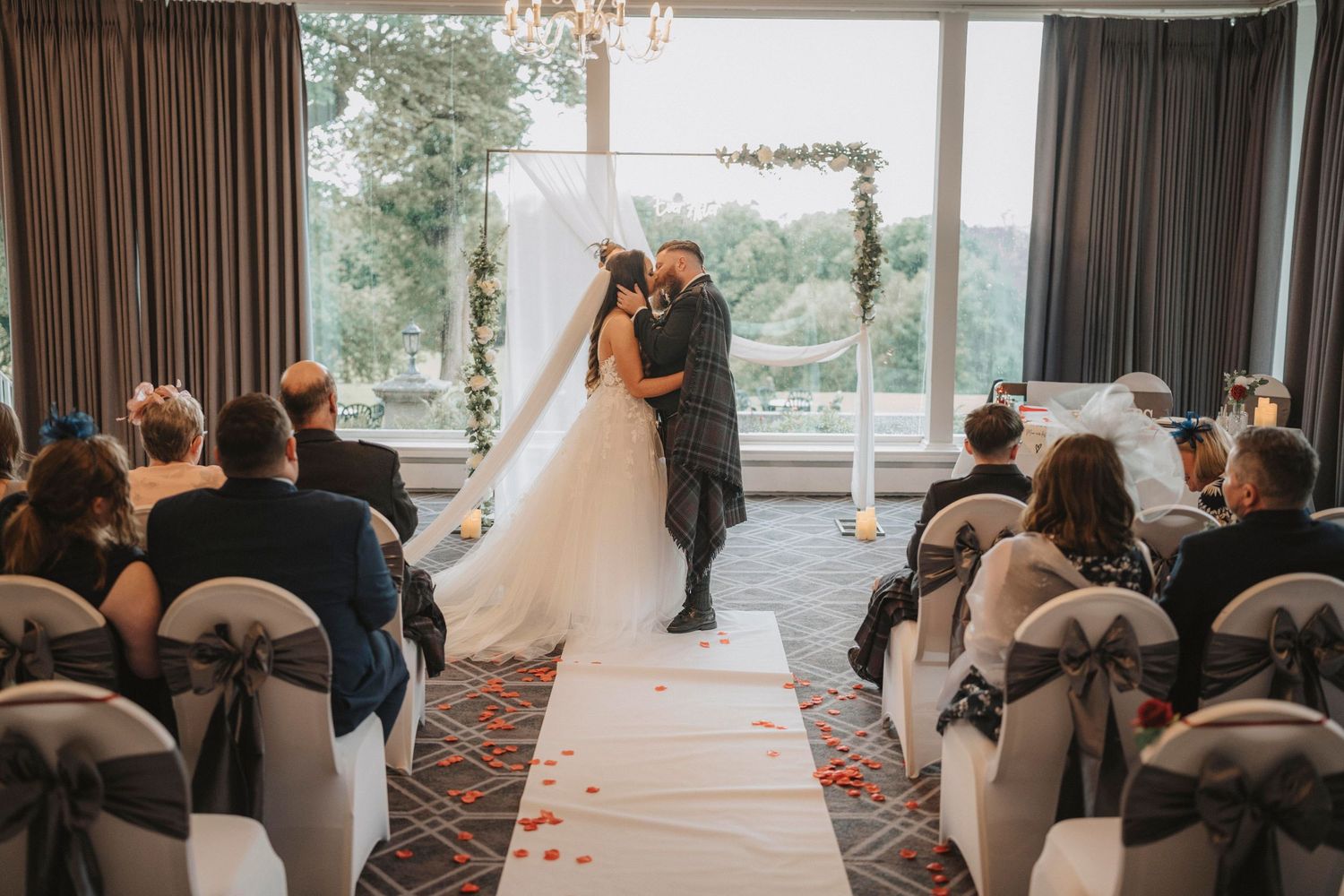 A sequence of candid wedding photos showing guests seated at tables and a couple walking down the aisle.