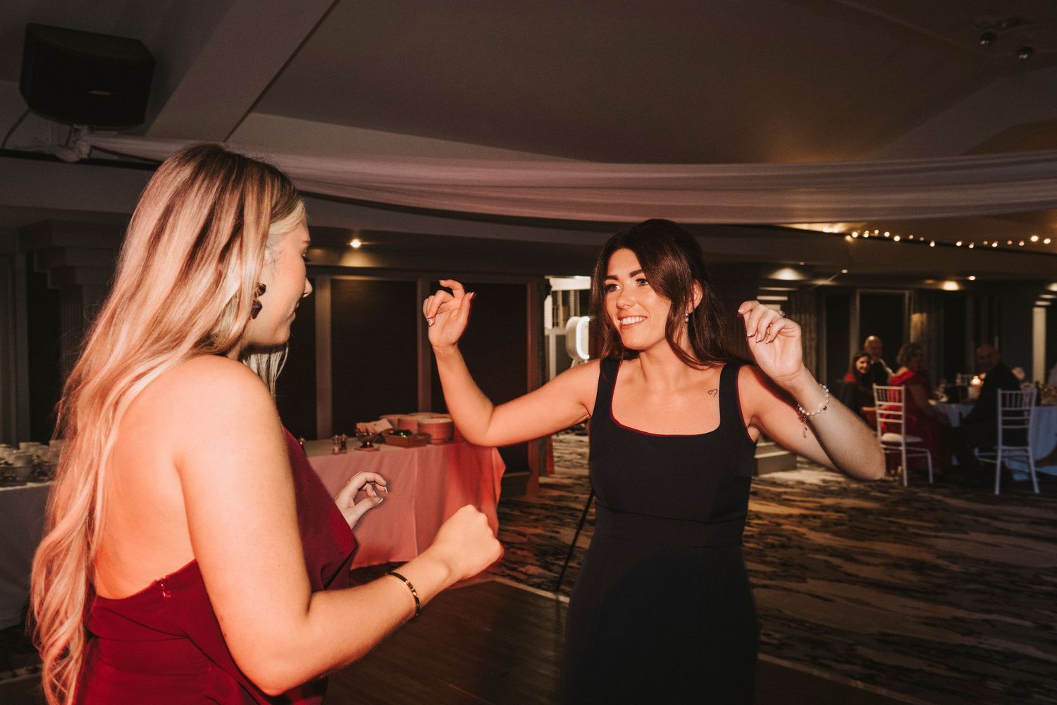 People dancing together in a dimly lit room during what appears to be a social dance event or party.
