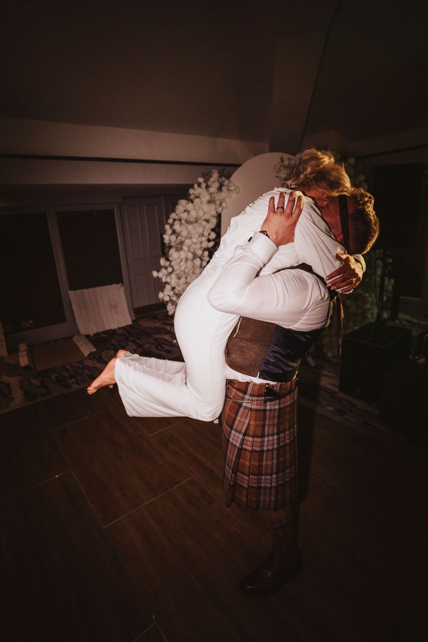 A sequence of dance moves shows a couple performing a traditional Scottish dance in a dimly lit room.