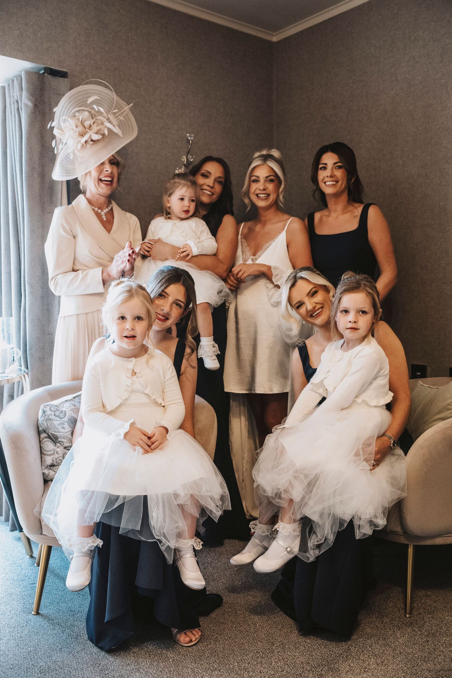 A collage of three photos showing a wedding party with bridesmaids in dark dresses and flower girls in white tulle dresses.