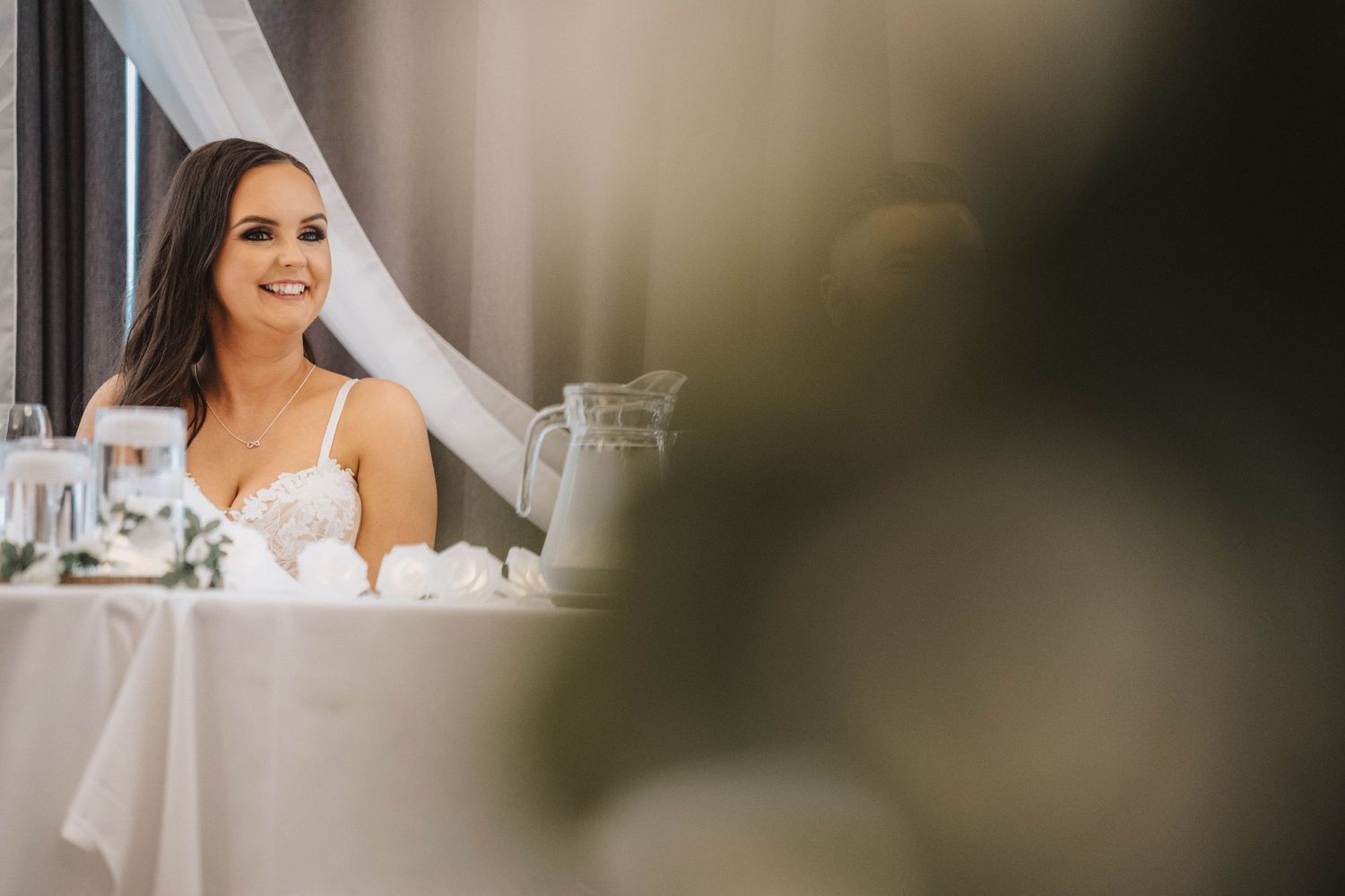 Elegant wedding reception setting with soft lighting and decorative details.