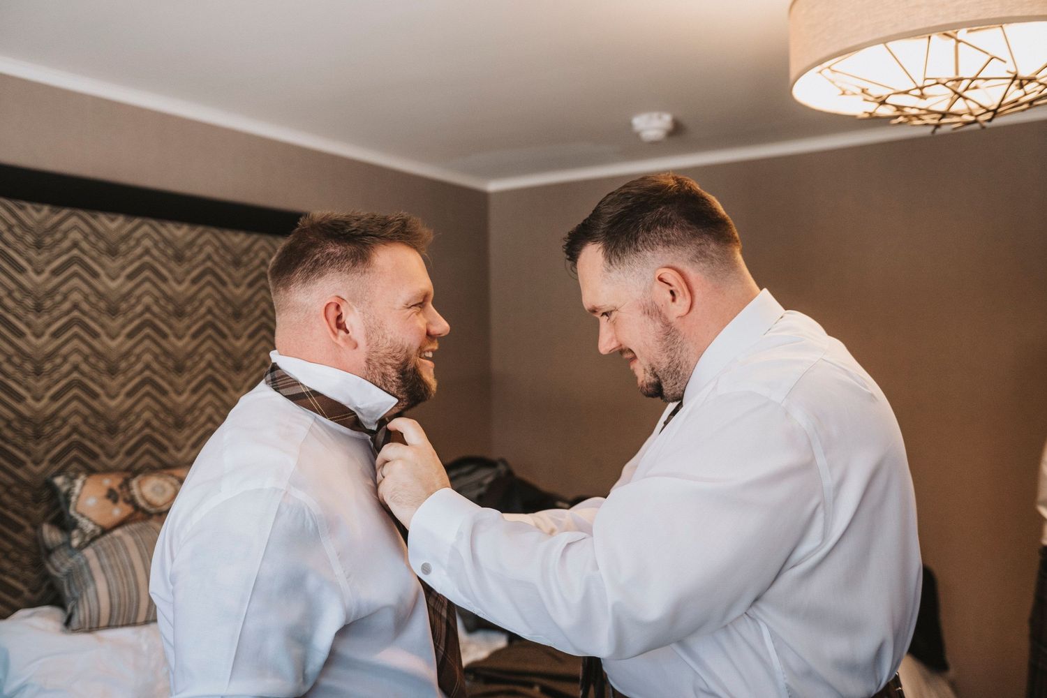 A series of candid moments showing people in white shirts and kilts getting ready for a formal event.