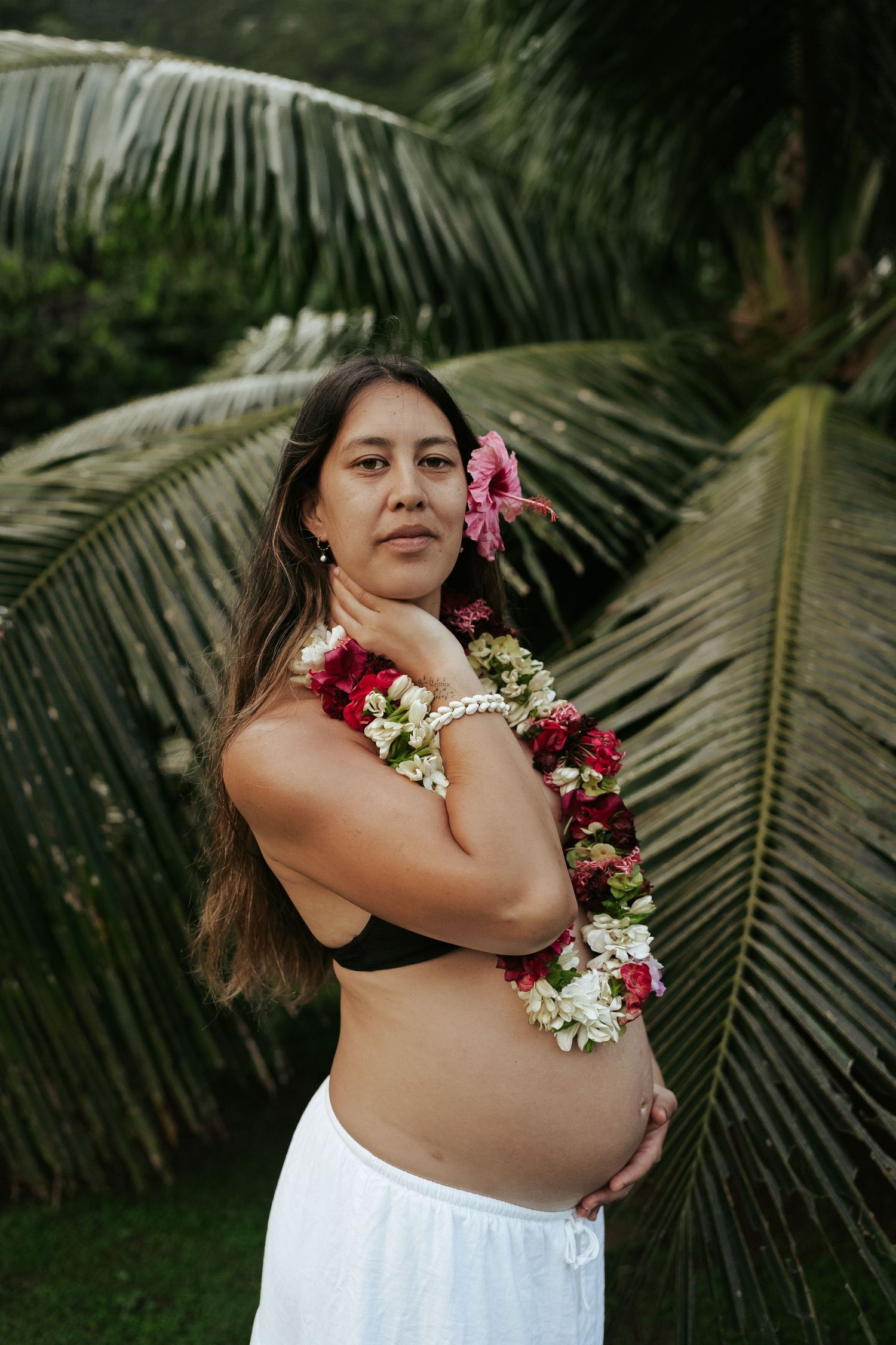 Pregnant women wearing a Rarotonga Flower garland and Hibiscus in her ear. Maternity Portrait