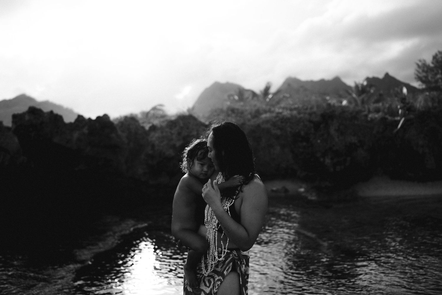 Black and White Image of a mum and son hugging in the water-Island Portrait