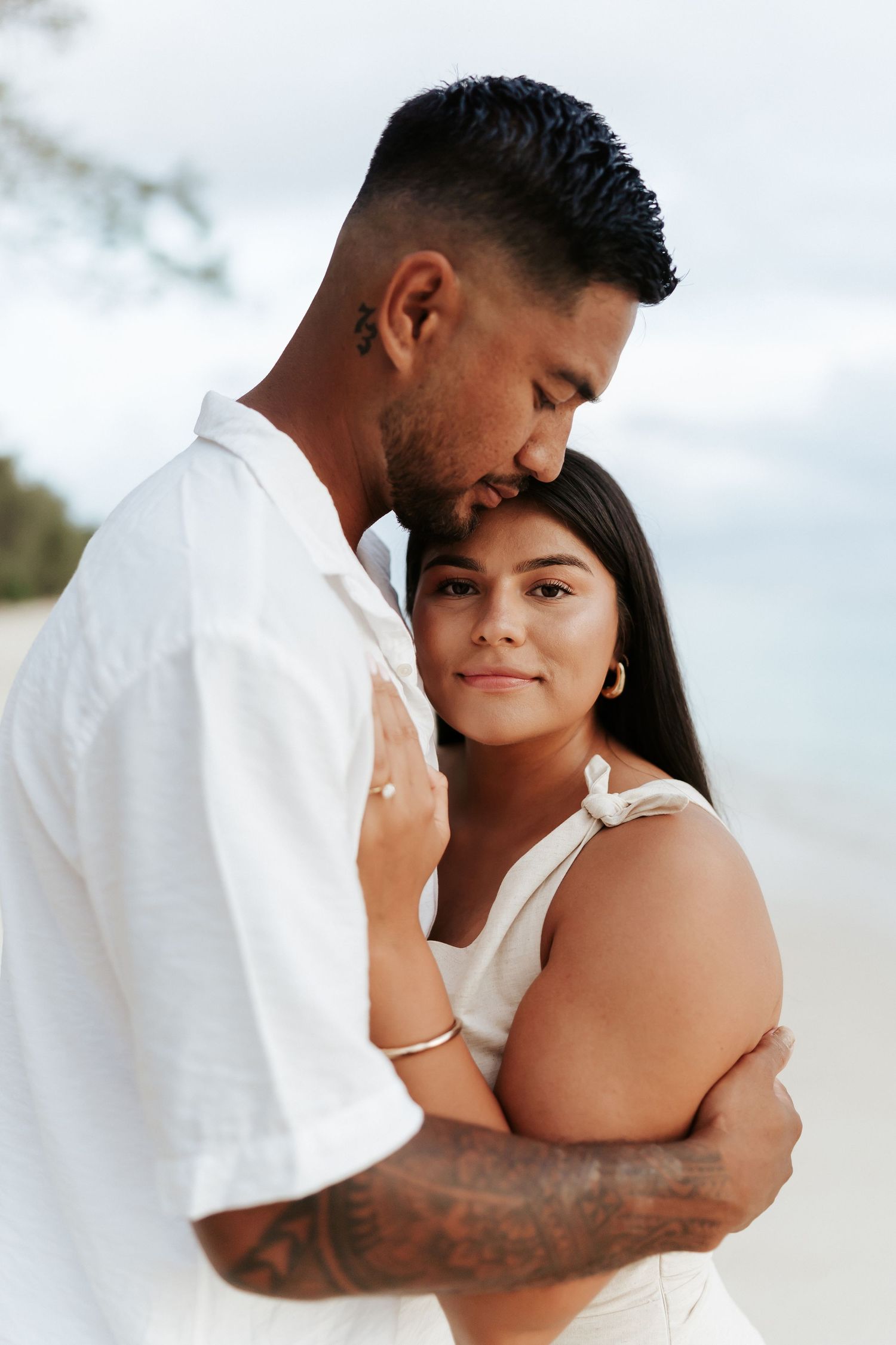 Groom holding bride in an intimate beach pose – romantic couples session in Rarotonga