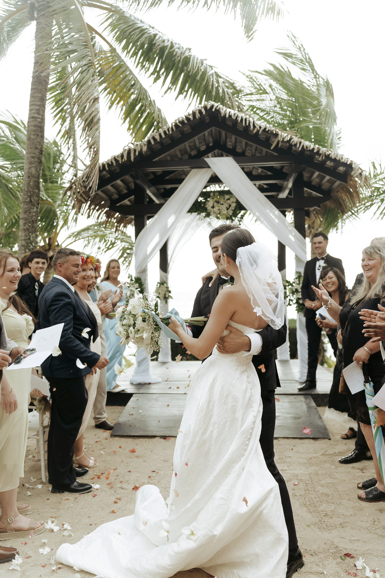 Couple dancing during reception under open-roof hut – wedding celebration in Cook Islands