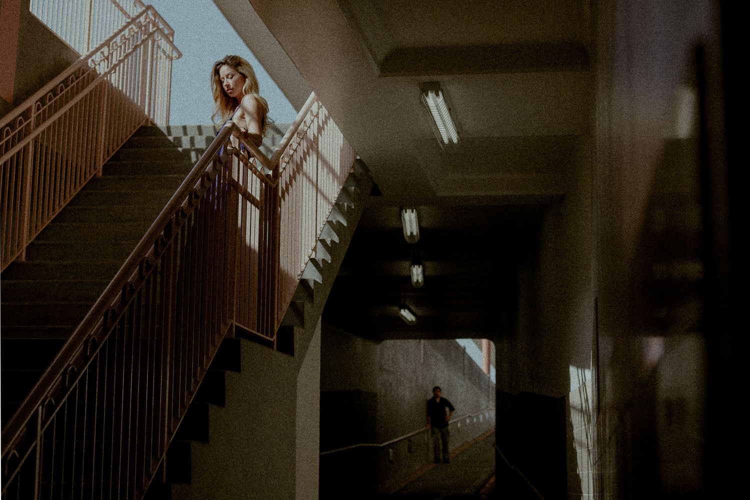 Moody indoor architecture photo with dramatic lighting and staircase composition.