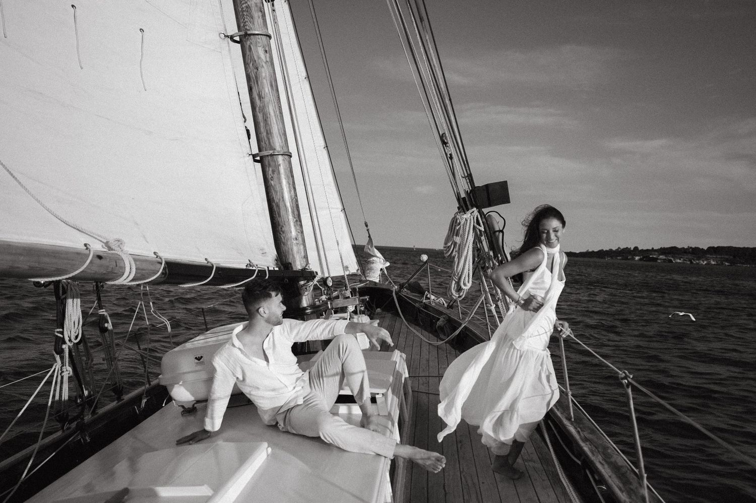 Black and white photo series showing sailing scenes with boats on the water and crew members aboard sailboats.