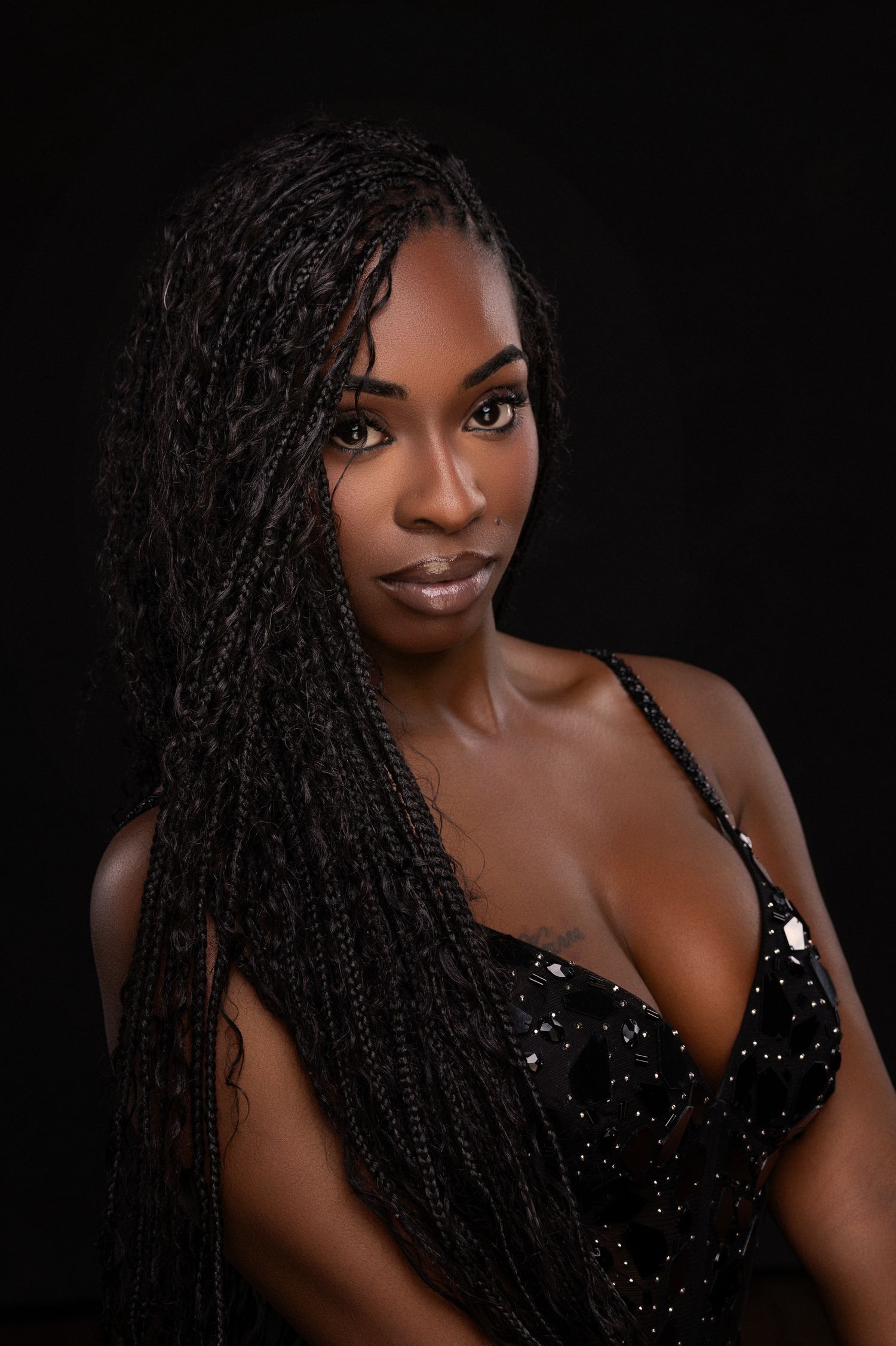 Glamour portrait series with sparkling black dress and dramatic lighting.
