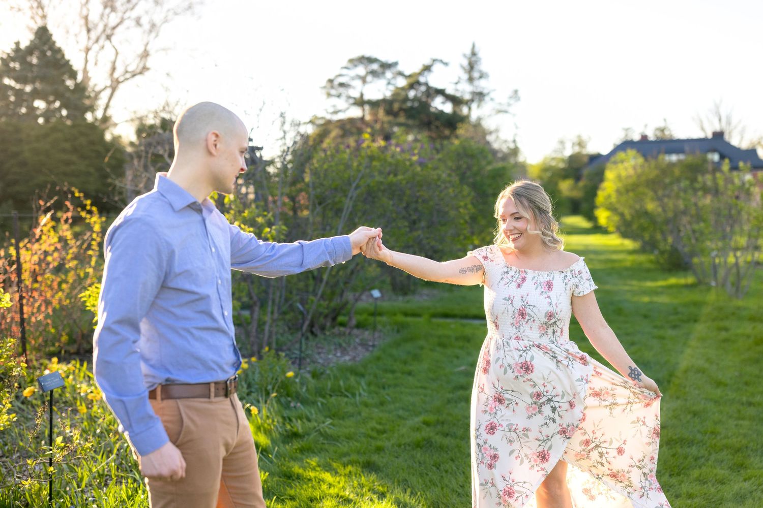 Dancing together in a sunny spring meadow during golden hour. Ottawa Wedding Photographer