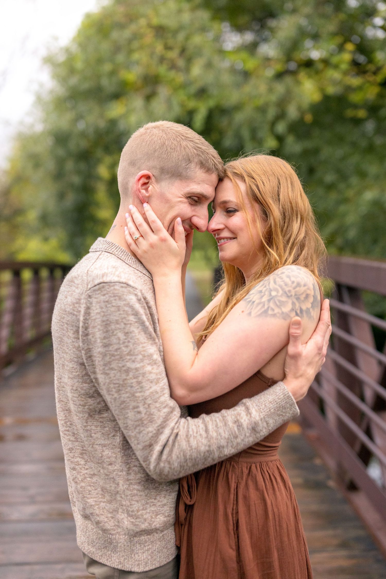 Intimate couple portrait session on wooden bridge with natural lighting. Ottawa Wedding Photographer