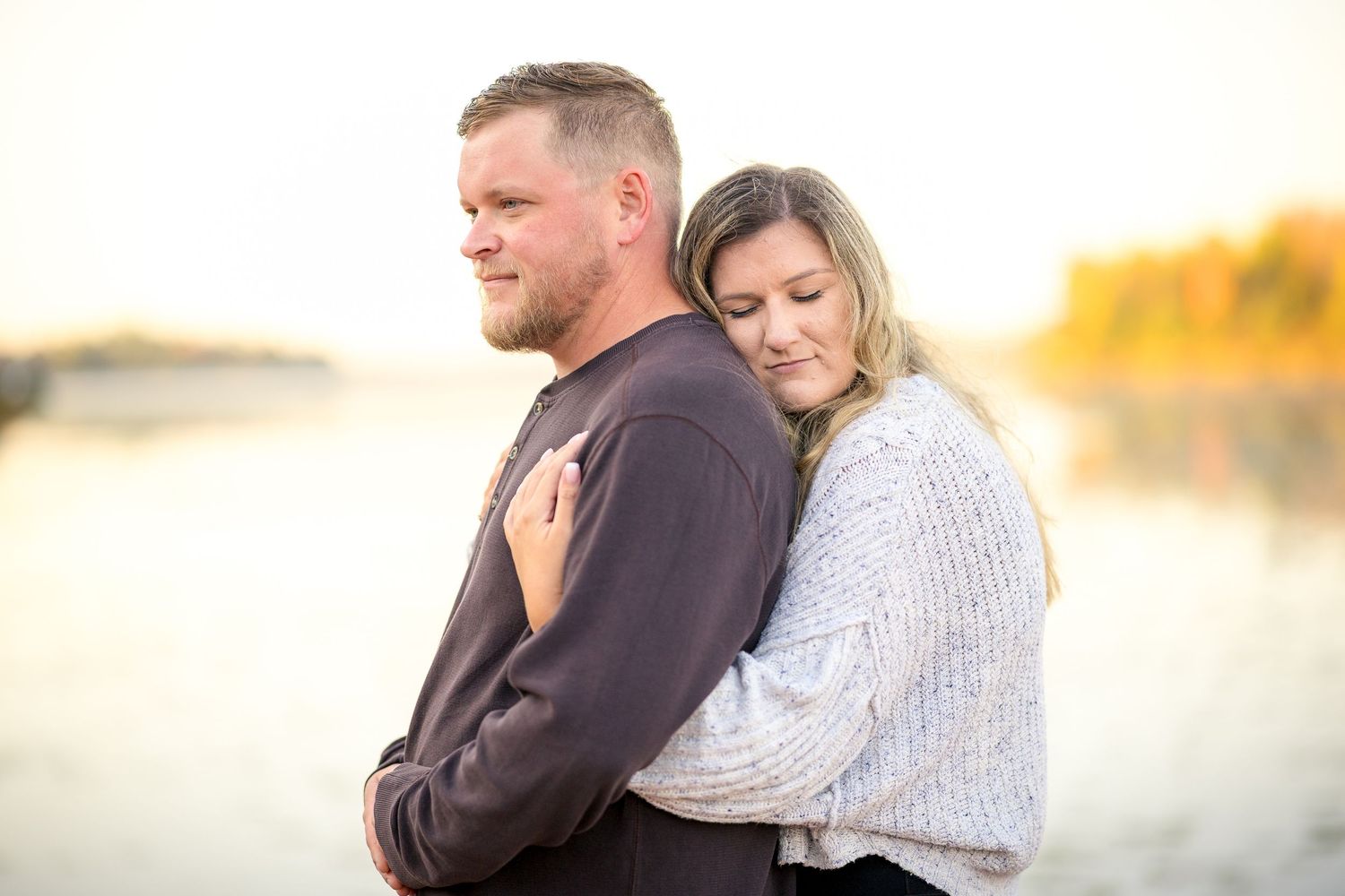 Couple sharing intimate moment at sunset by waterfront. Ottawa Portrait Photographer