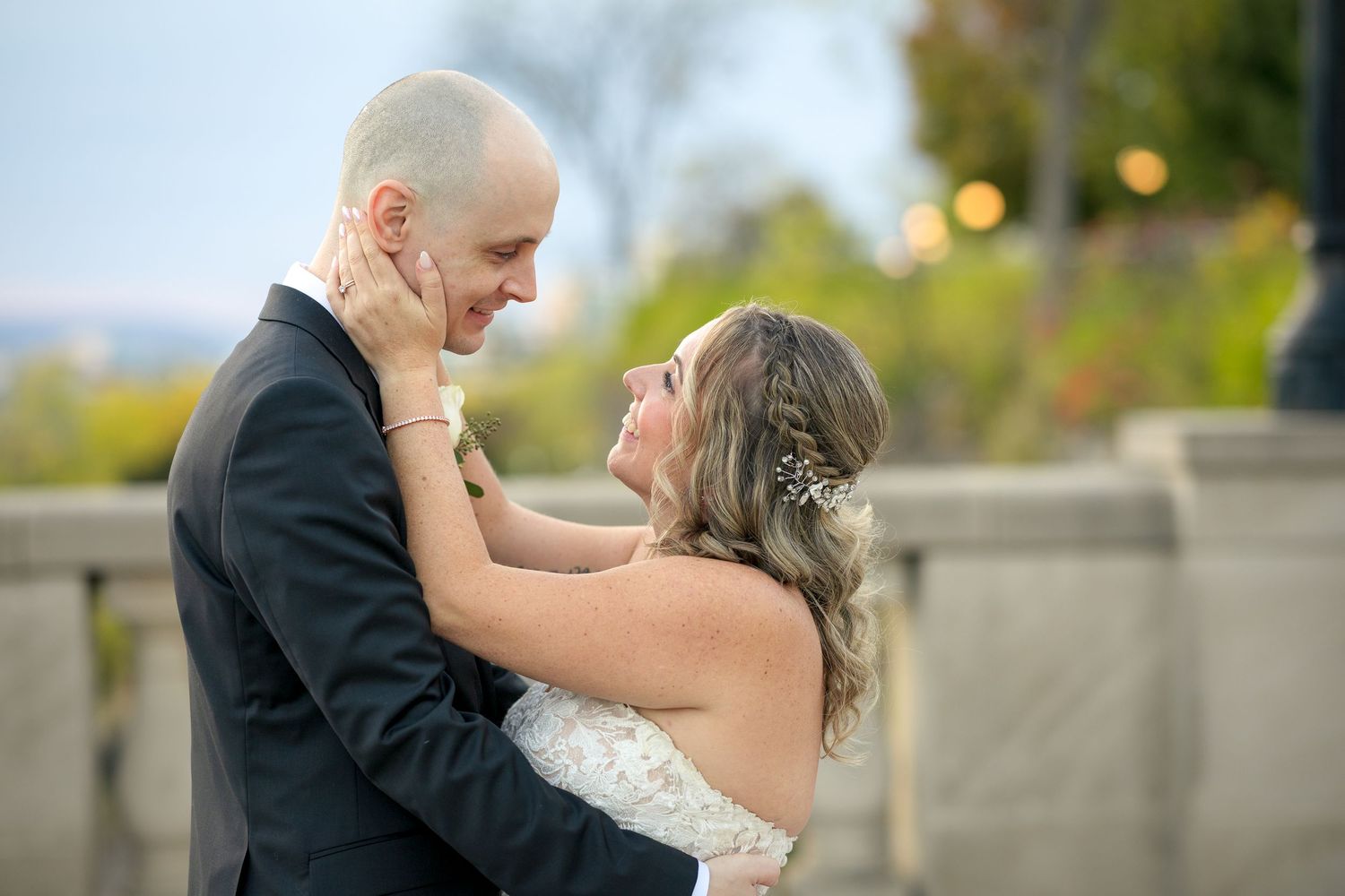A couple in wedding attire share a romantic embrace outdoors during their special wedding day. Ottawa wedding photographer