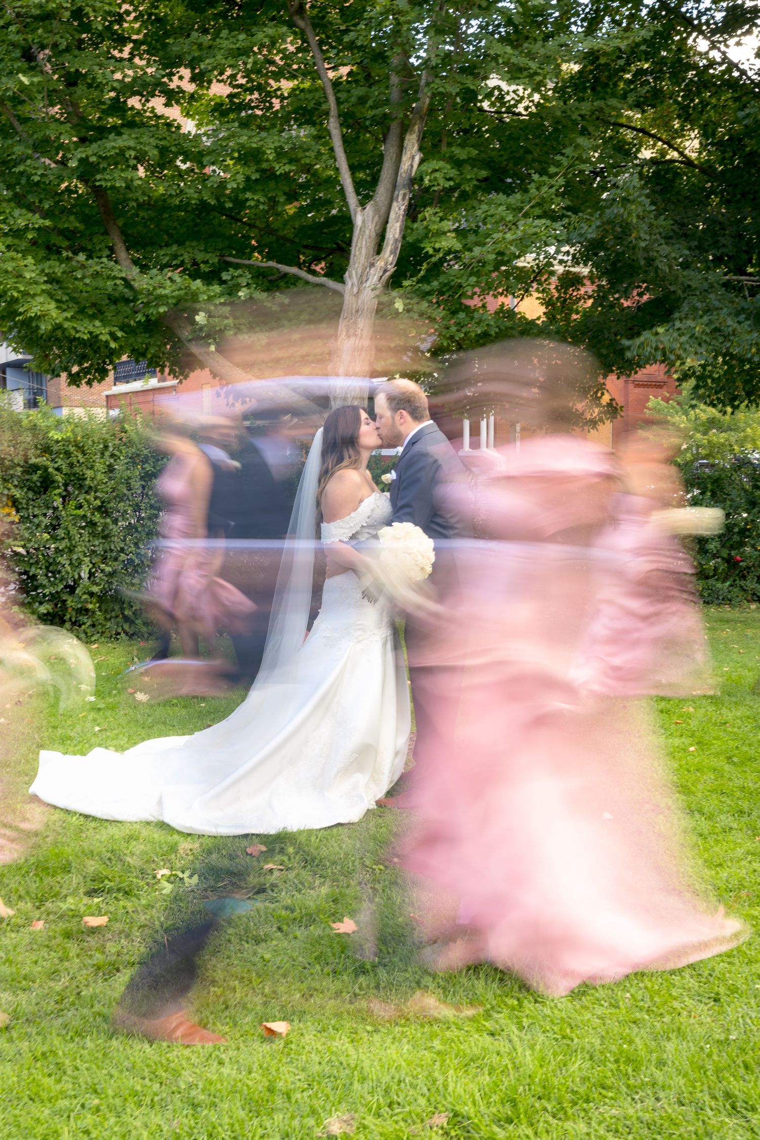 Motion blur sequence shows a couple outdoors in wedding attire with the wedding party dancing. Ottawa Wedding Photographer