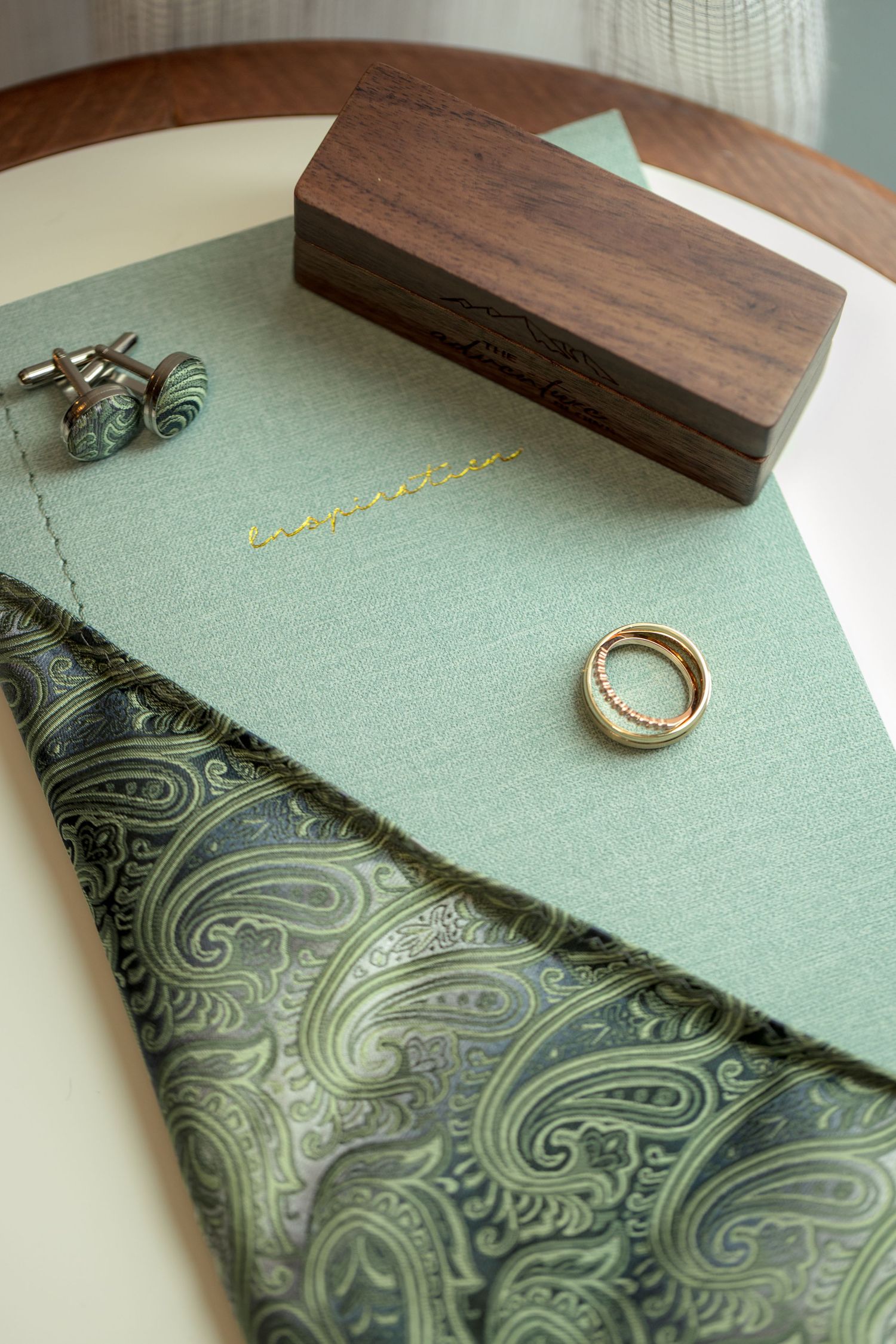 Wooden ring box with green patterned fabric shown in a flat lay. Ottawa Wedding Photographer