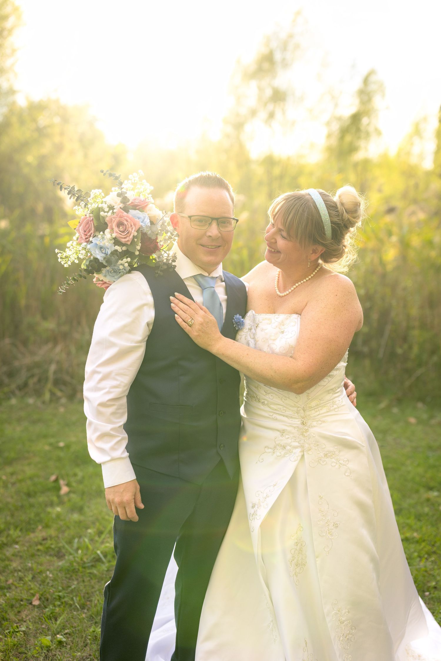 A romantic outdoor wedding scene with a couple sharing a joyful moment together in golden sunlight. Ottawa wedding photographer