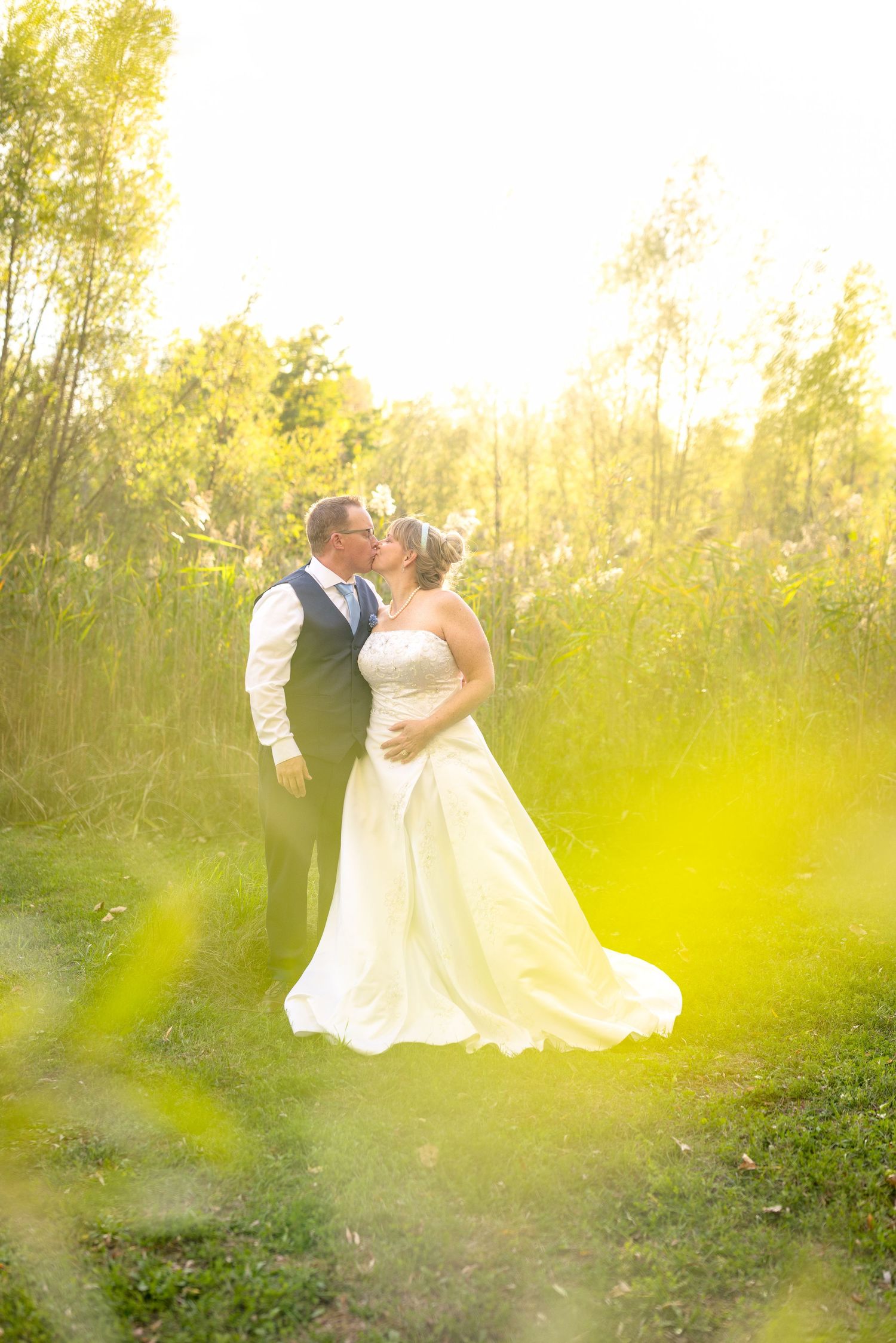 A sweet wedding moment captured in a series of photos showing a couple embracing in natural sunlit grove. Ottawa Wedding Photography