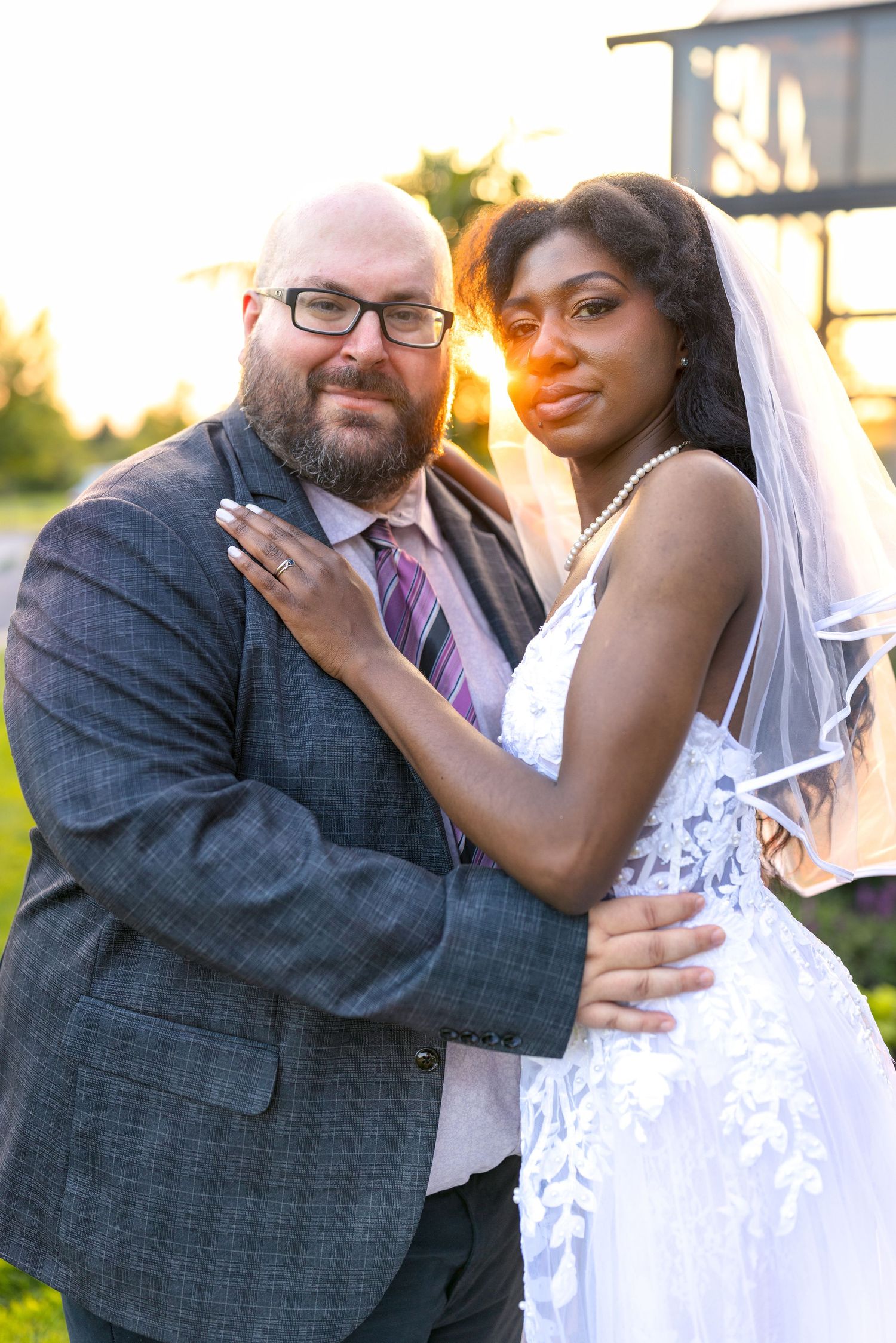 A romantic wedding couple embraces together during golden hour sunset in a series of candid moments. Aquatopia Ottawa wedding photographer