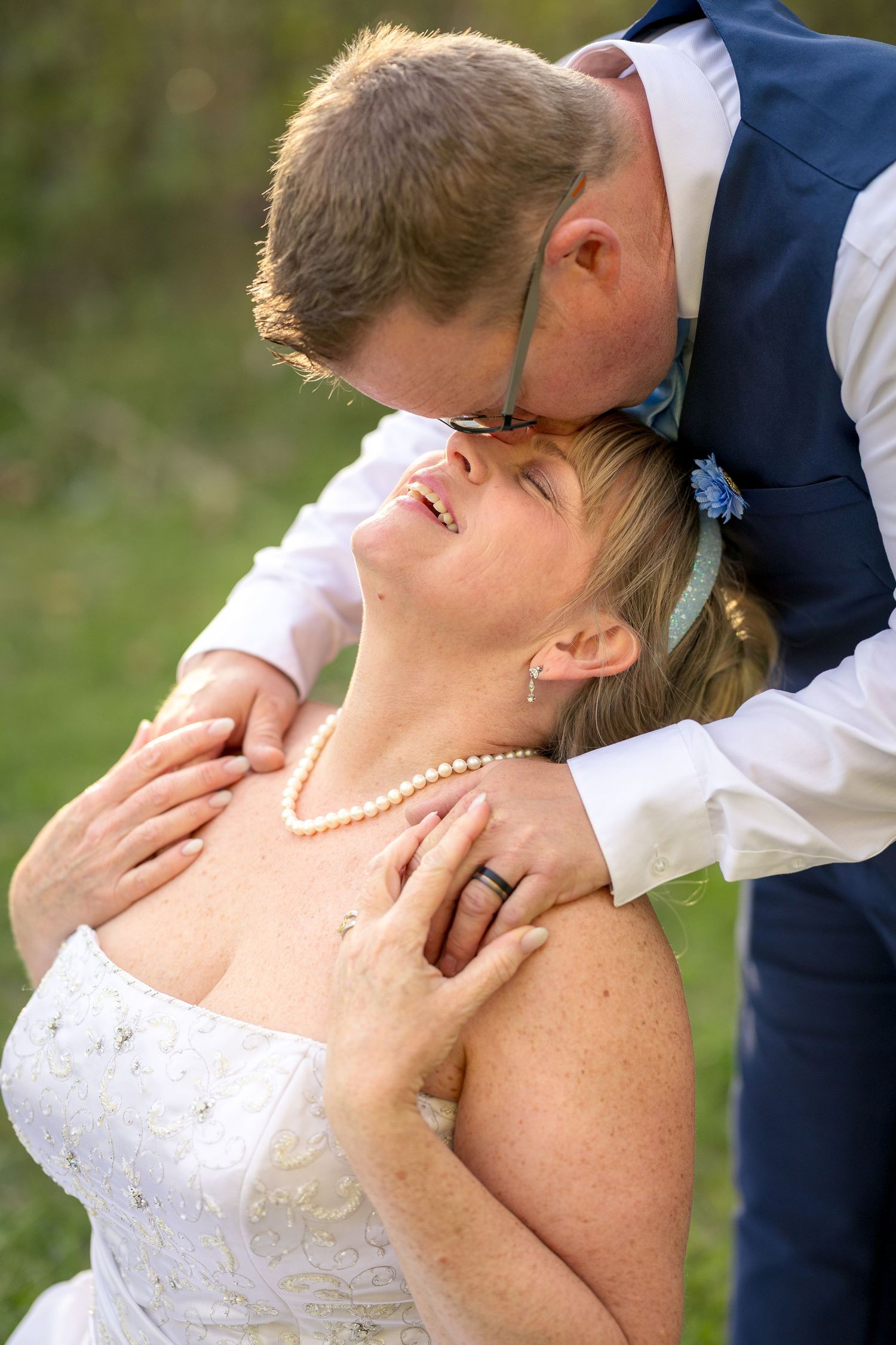 A romantic wedding photography sequence shows a couple sharing an intimate kiss in an outdoor garden setting. Ottawa Wedding photographer