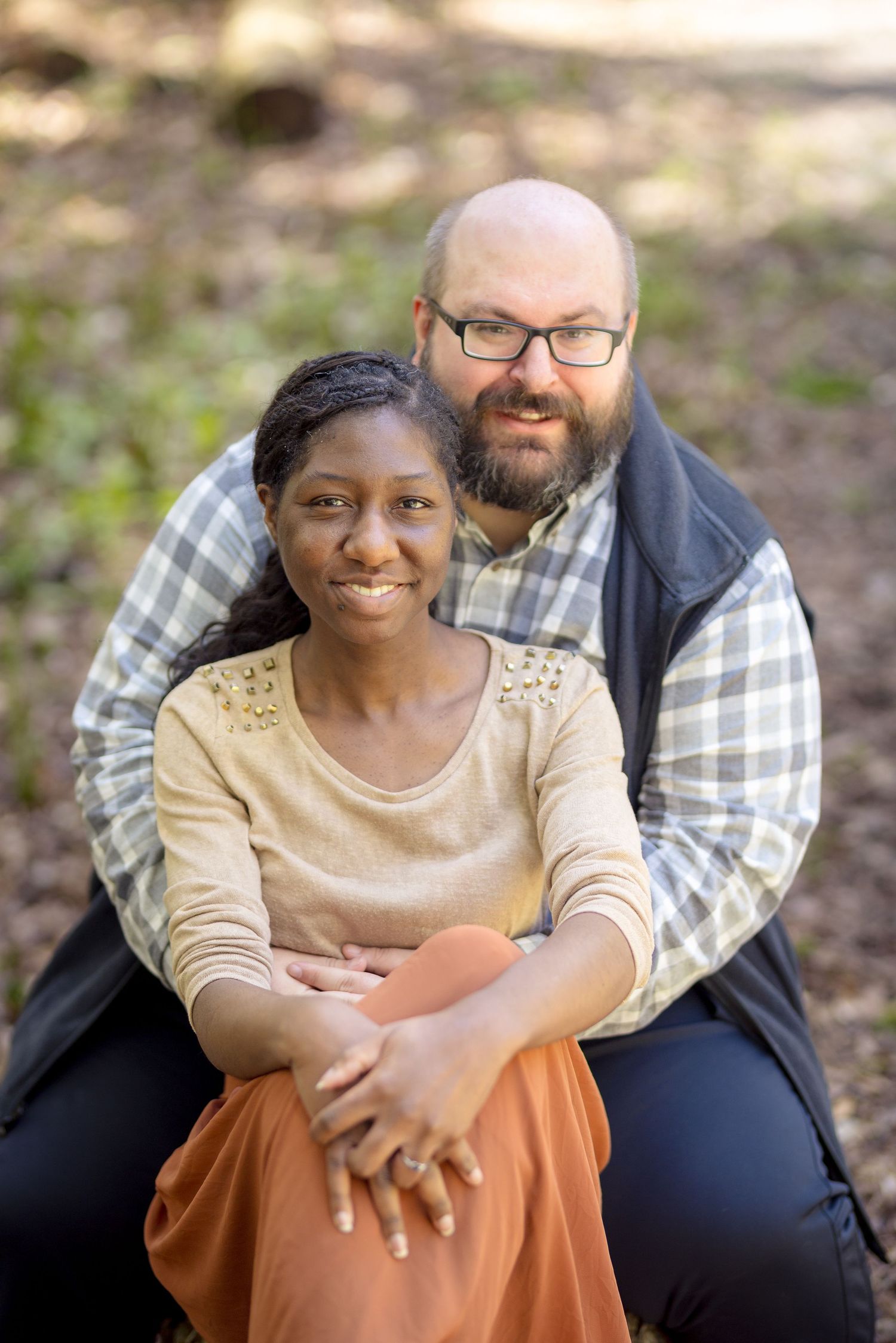 Couple sitting together on forest ground sharing intimate moments. Ottawa Wedding Photographer