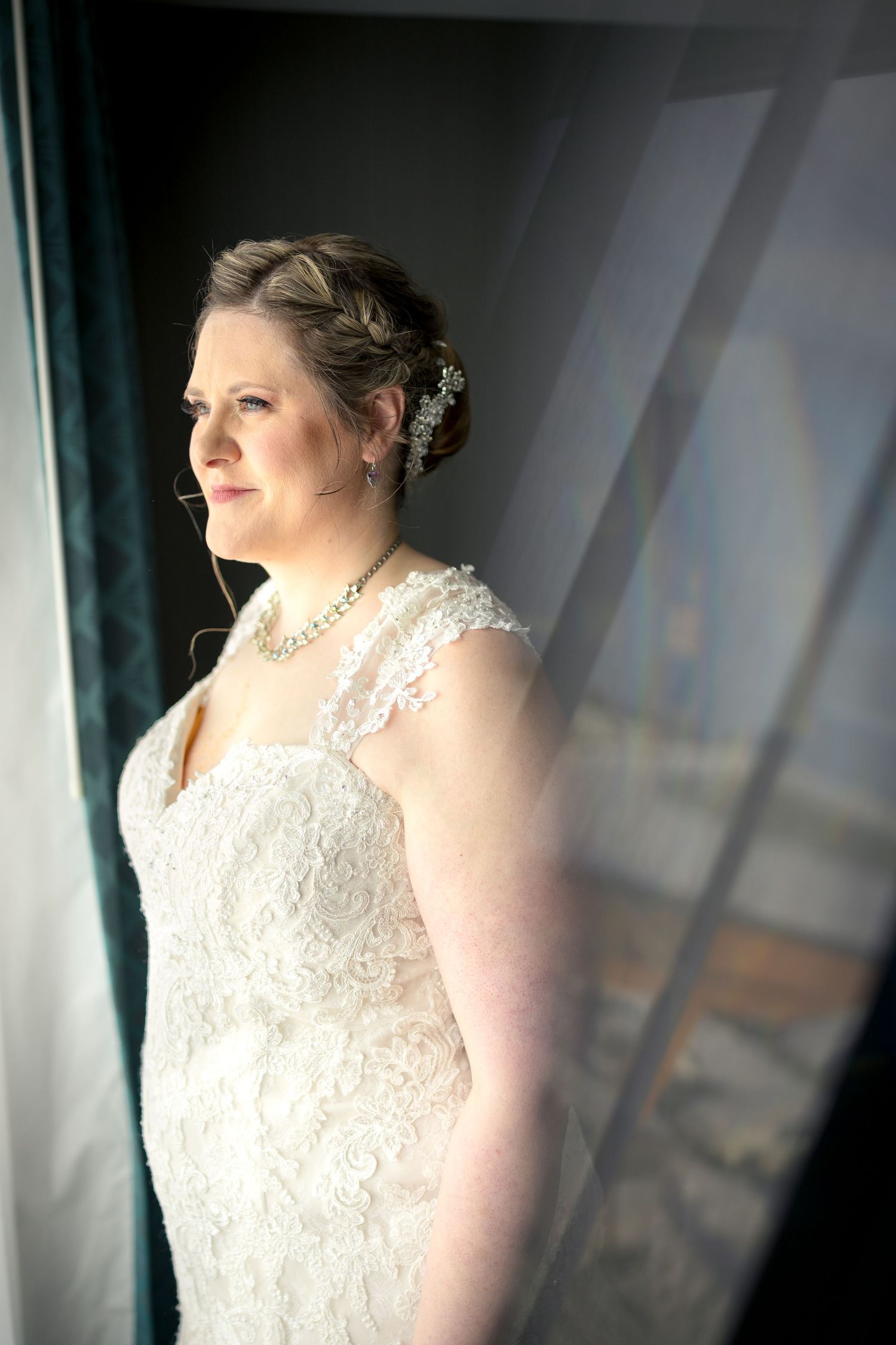 A dreamy wedding portrait showing a bride in a white lace dress against a soft, ethereal background. Ottawa wedding photographer